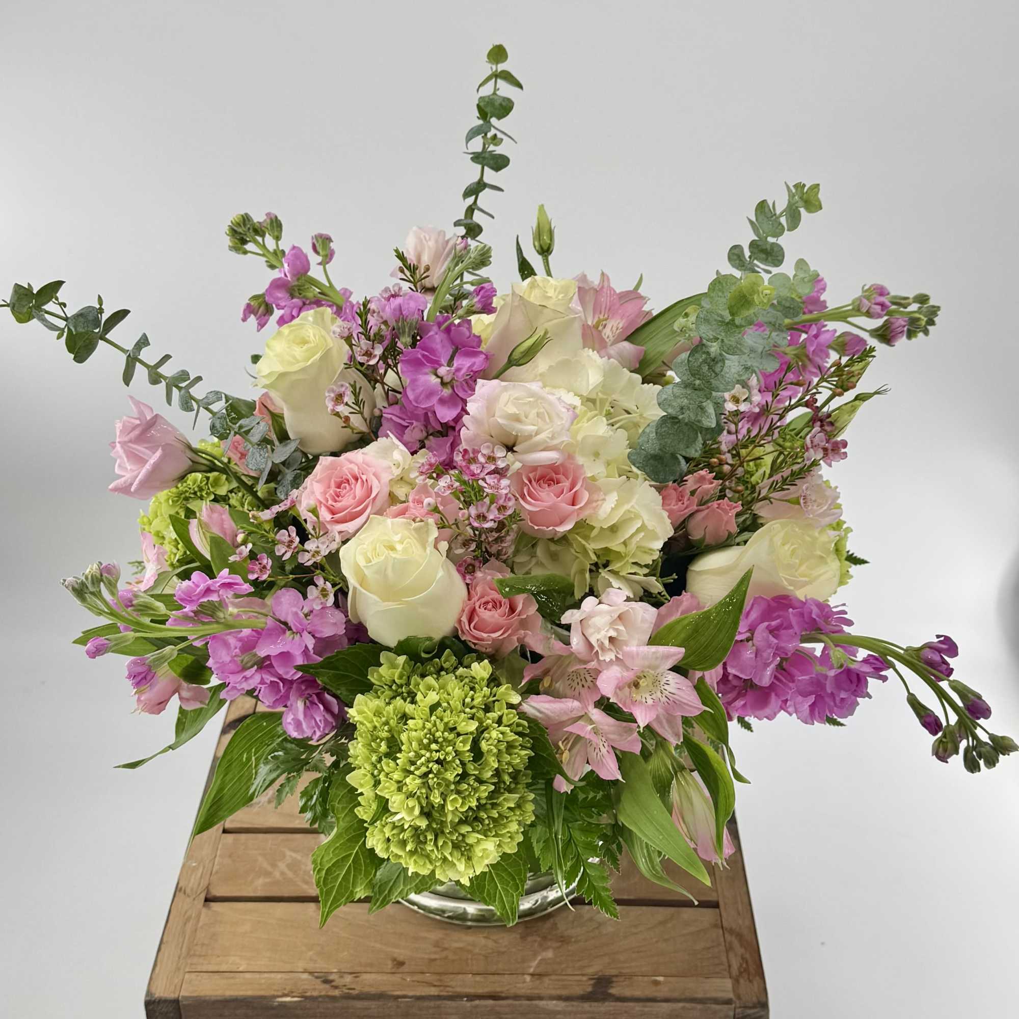 Introducing our premium floral arrangement, dazzling with shades of green, white, pink