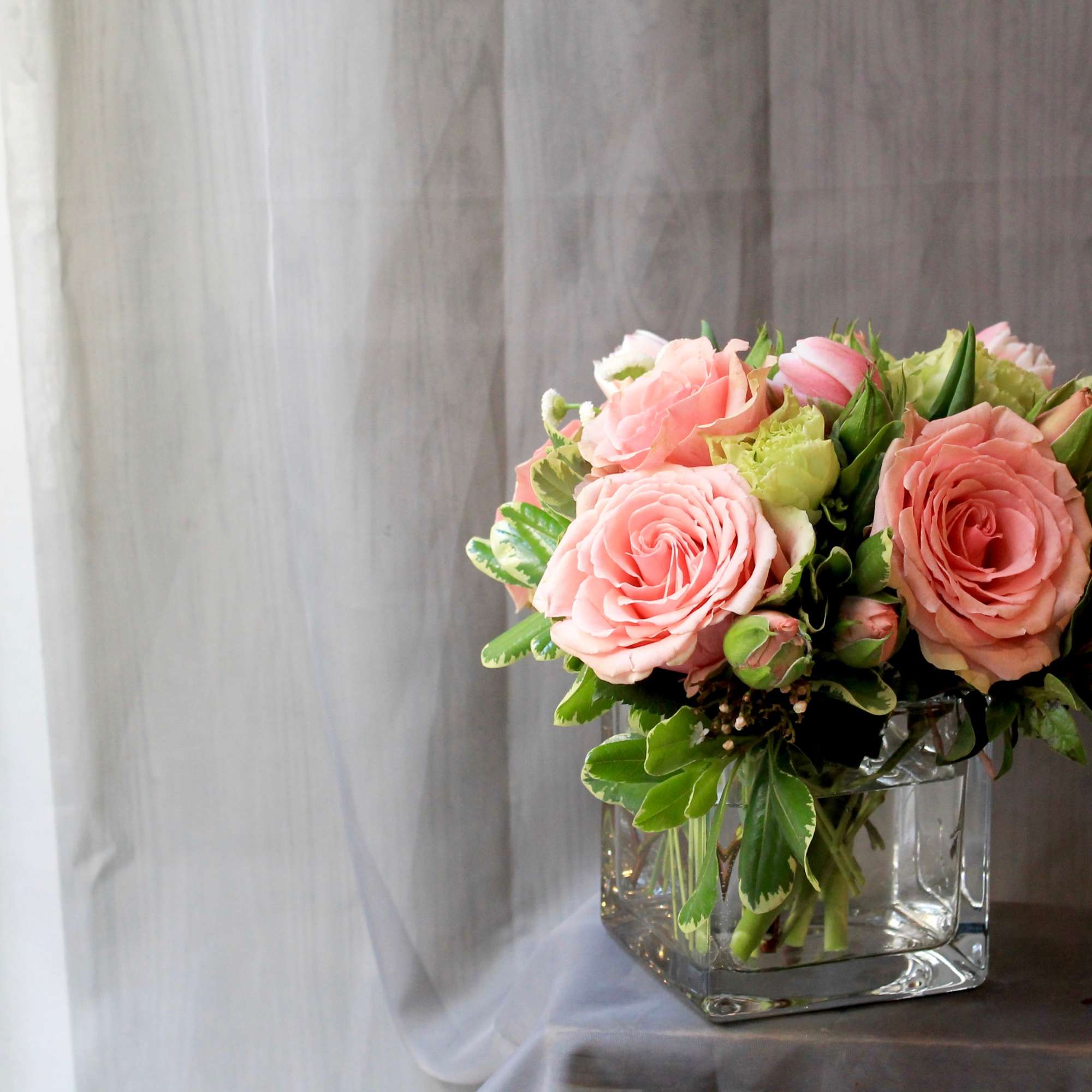 Cute 4x4 cube vase with pretty pink roses and greenery. A perfect