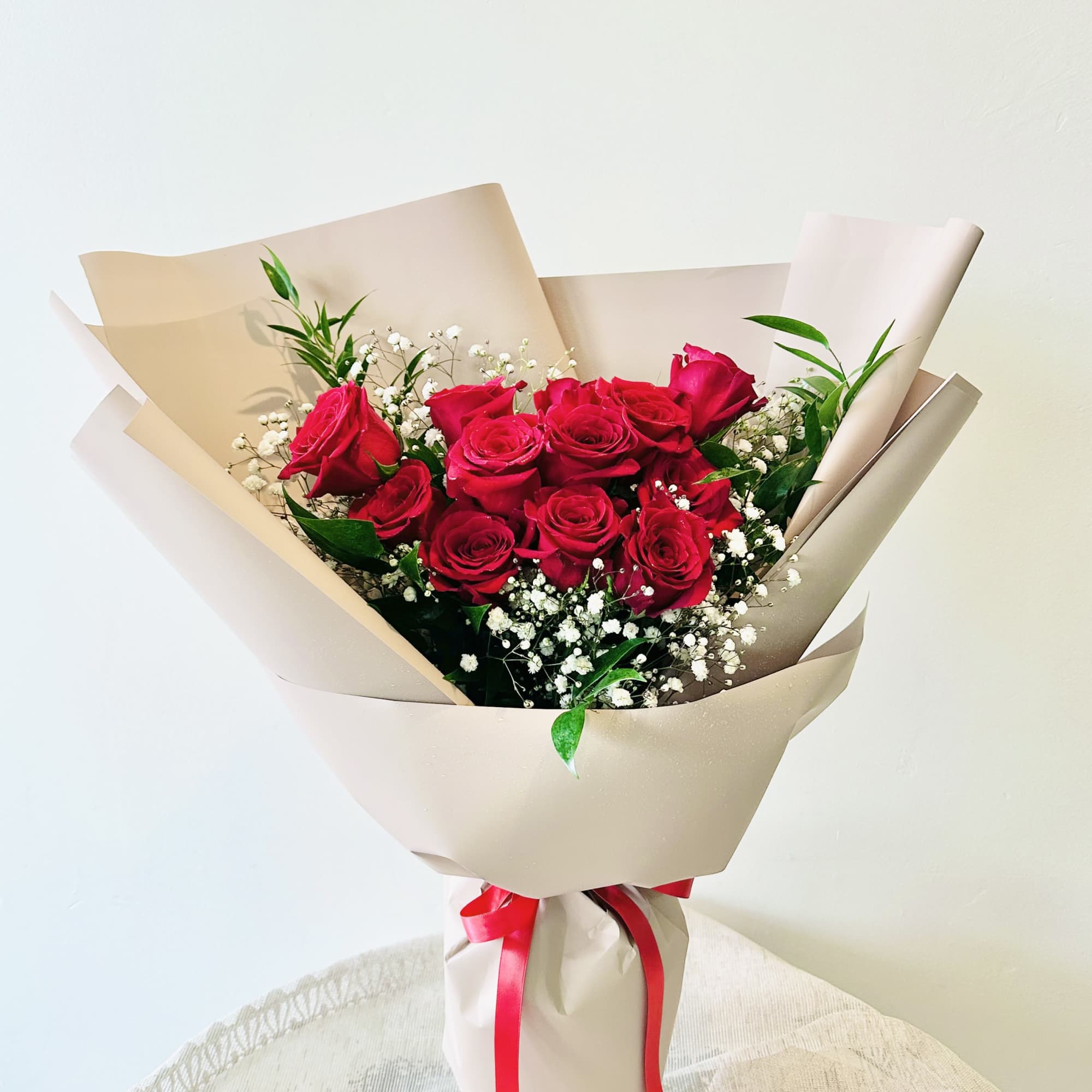 Dozen red roses tied in a hand bouquet
This bouquet does not come