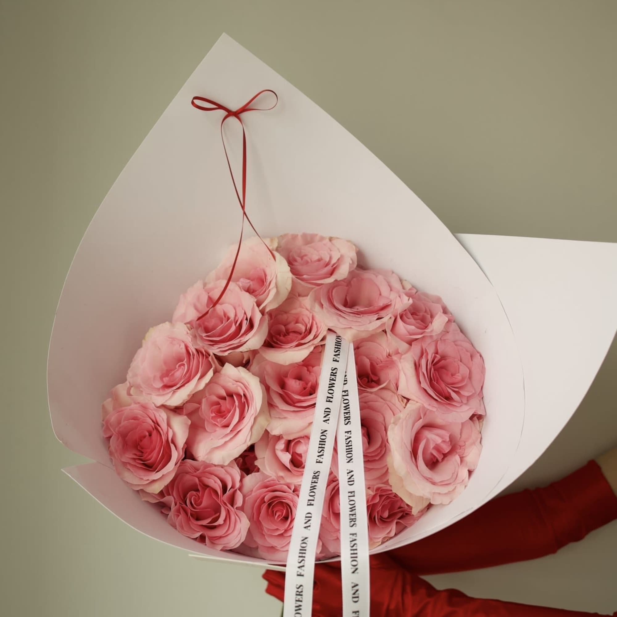 A delicate bouquet of fresh pink roses, thoughtfully arranged in a clean