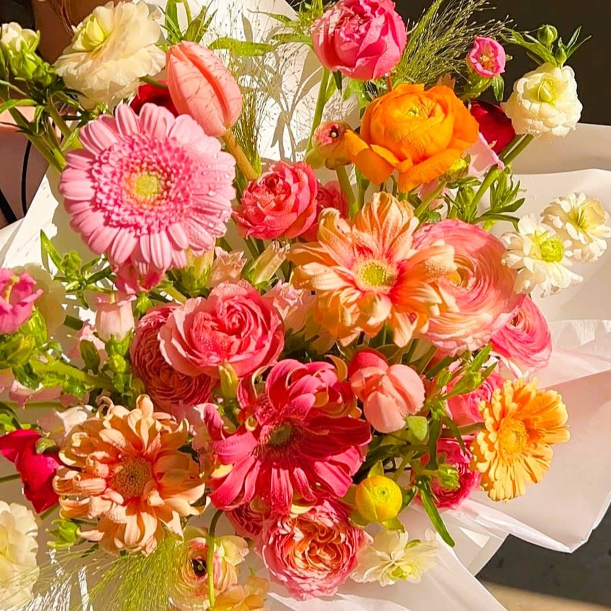 Custom mixed bouquets are wrapped in kraft paper or color plastic paper