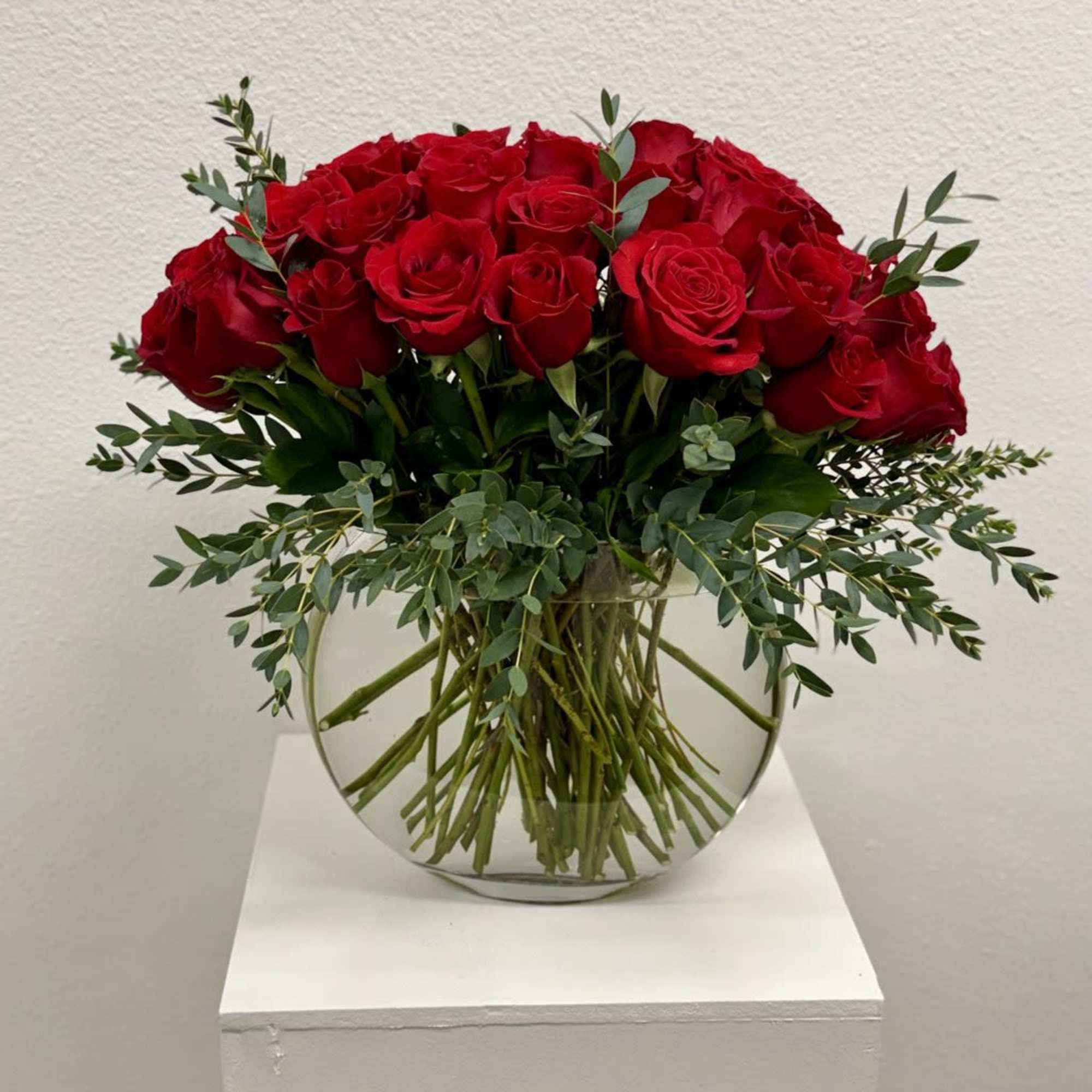 Three dozen luxurious red Roses arranged in Glass bubble glass are an