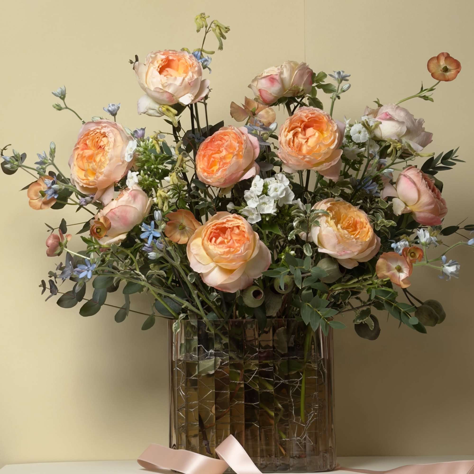 This stunning arrangement features Princess Aiko garden roses softly cradled by blue