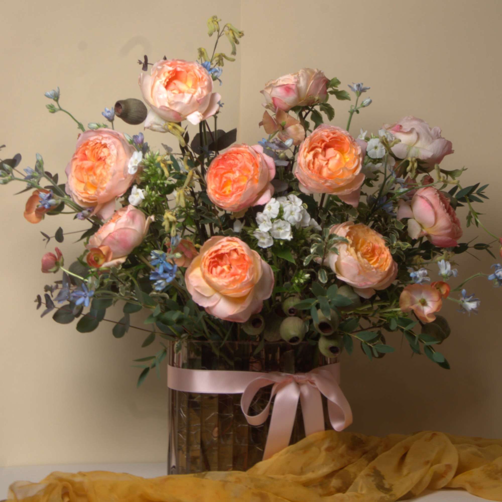 This stunning arrangement features Princess Aiko garden roses softly cradled by blue
