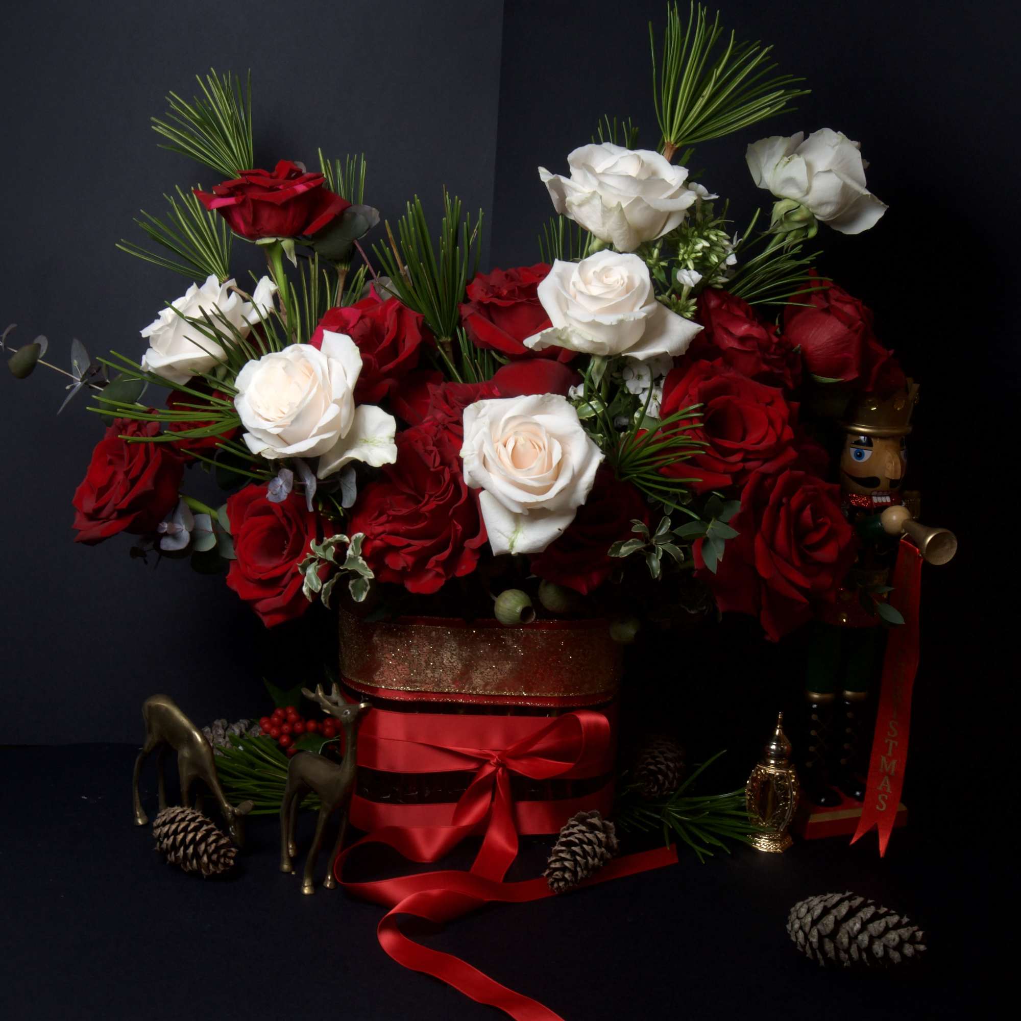 This elegant arrangement features a striking blend of rich red and creamy