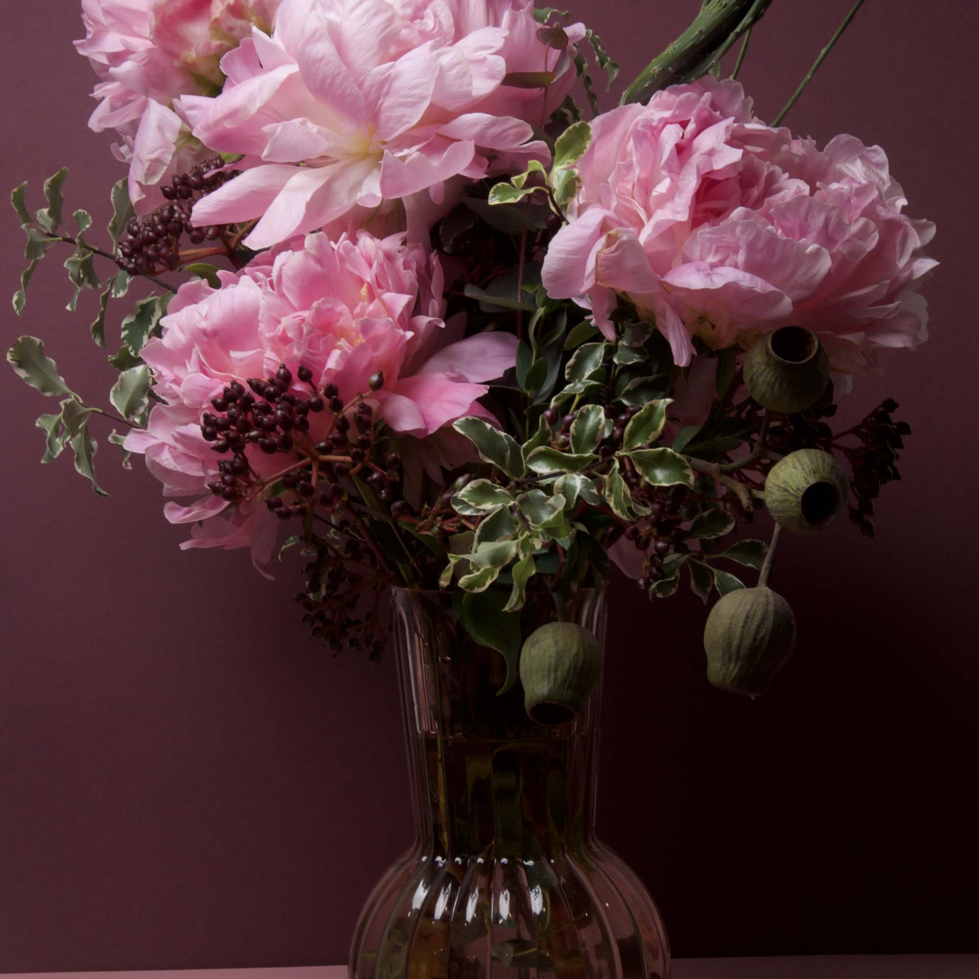 This arrangement displays large, showy peony blooms arranged with natural grace and