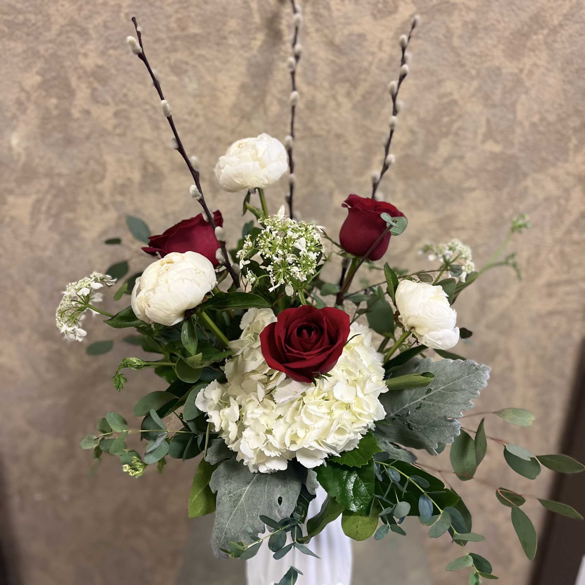Type of Flowers: White Peonies, Red Roses, Pussy Willow, and Eucalyptus in