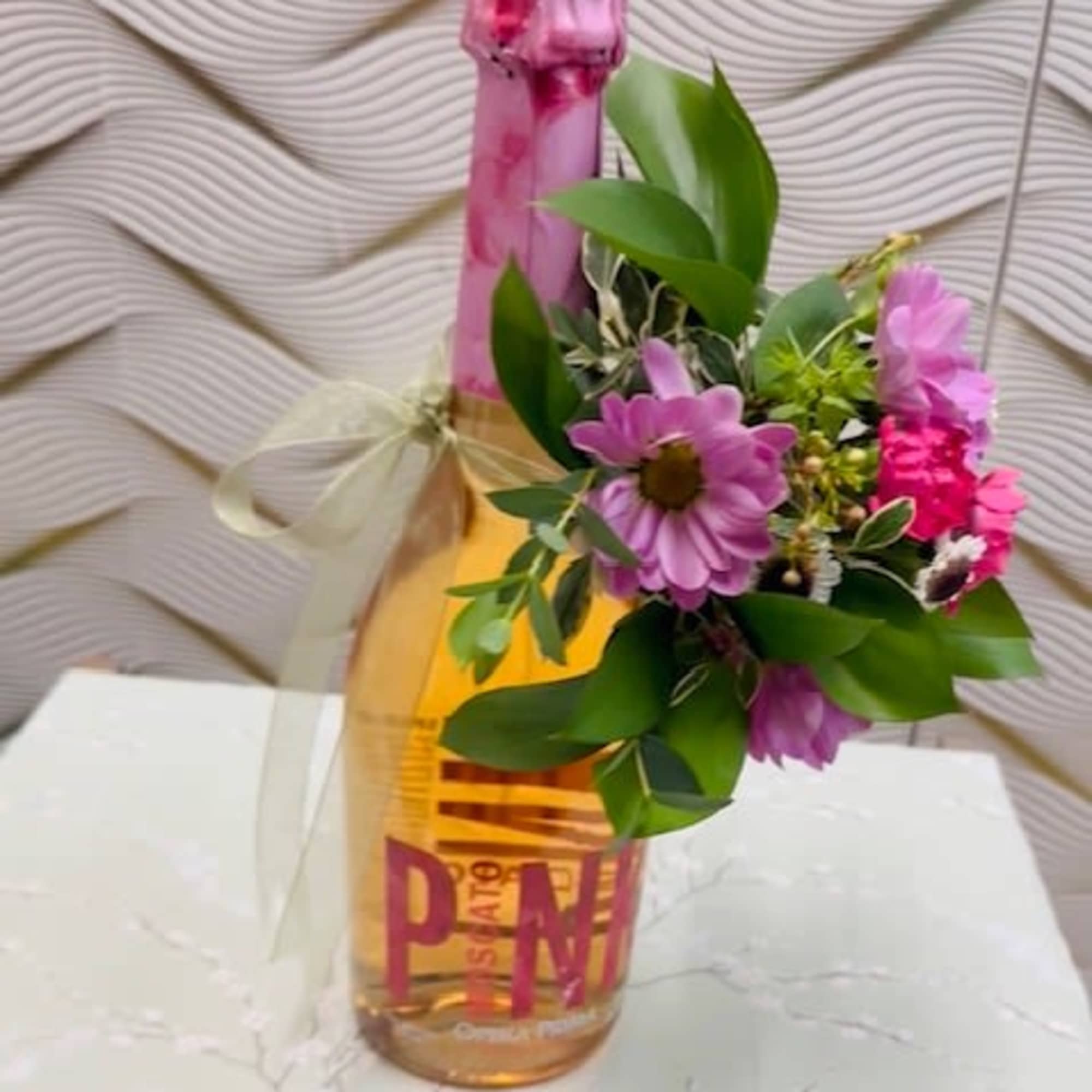 Get free complimentary wine bottle decorated with fresh cut flower arrangement in