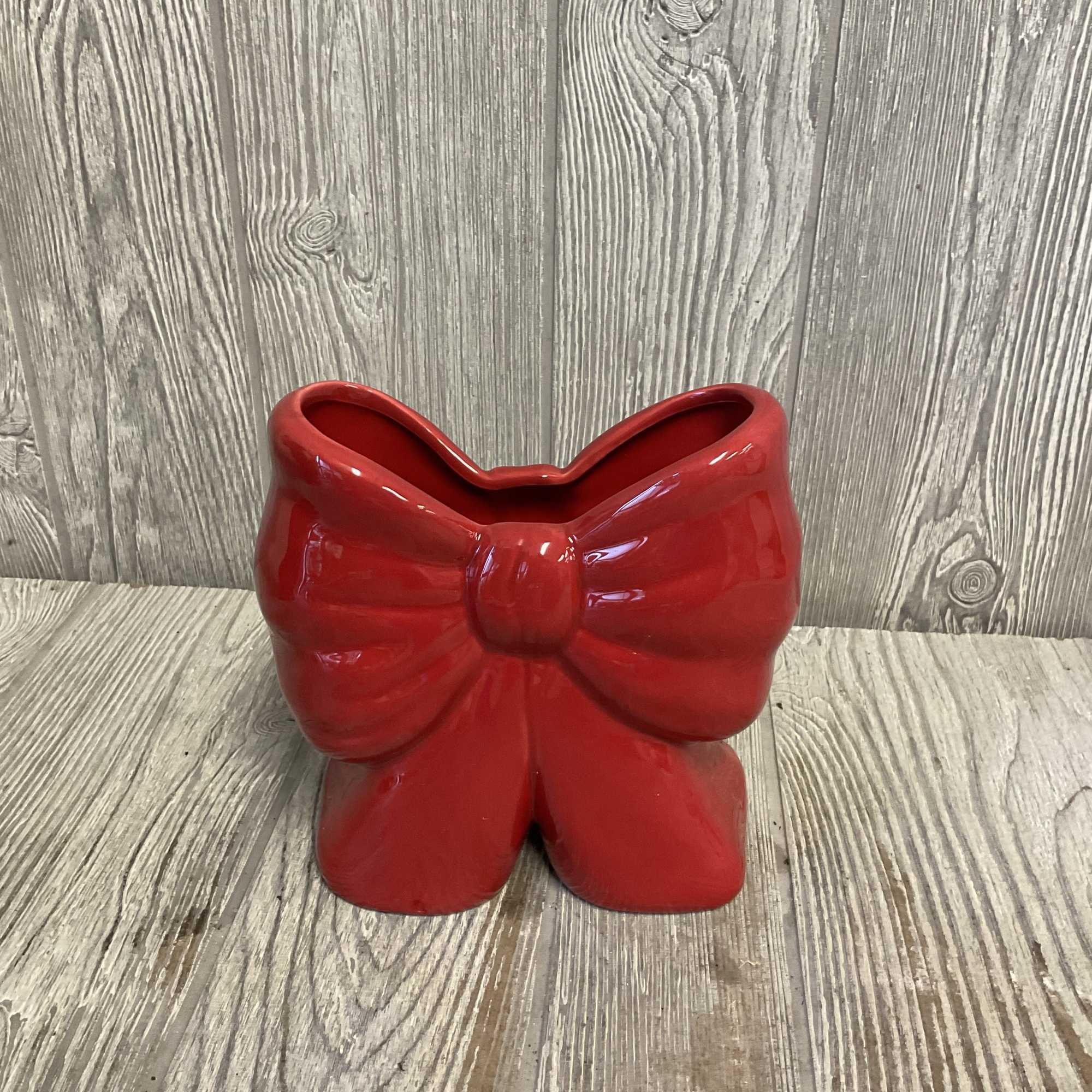 Fresh cute flowers arranged in a keepsake ceramic red bow vase. Flowers