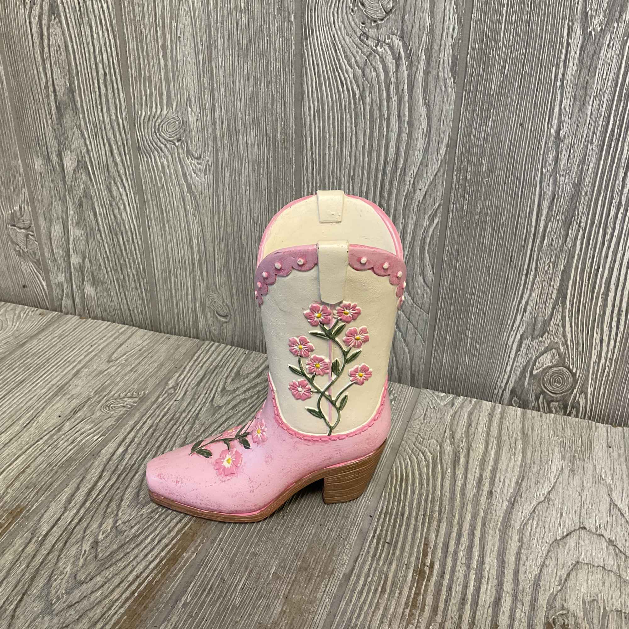 Beautiful fresh cut flowers arranged in a sweet keepsake cowgirl boot vase.