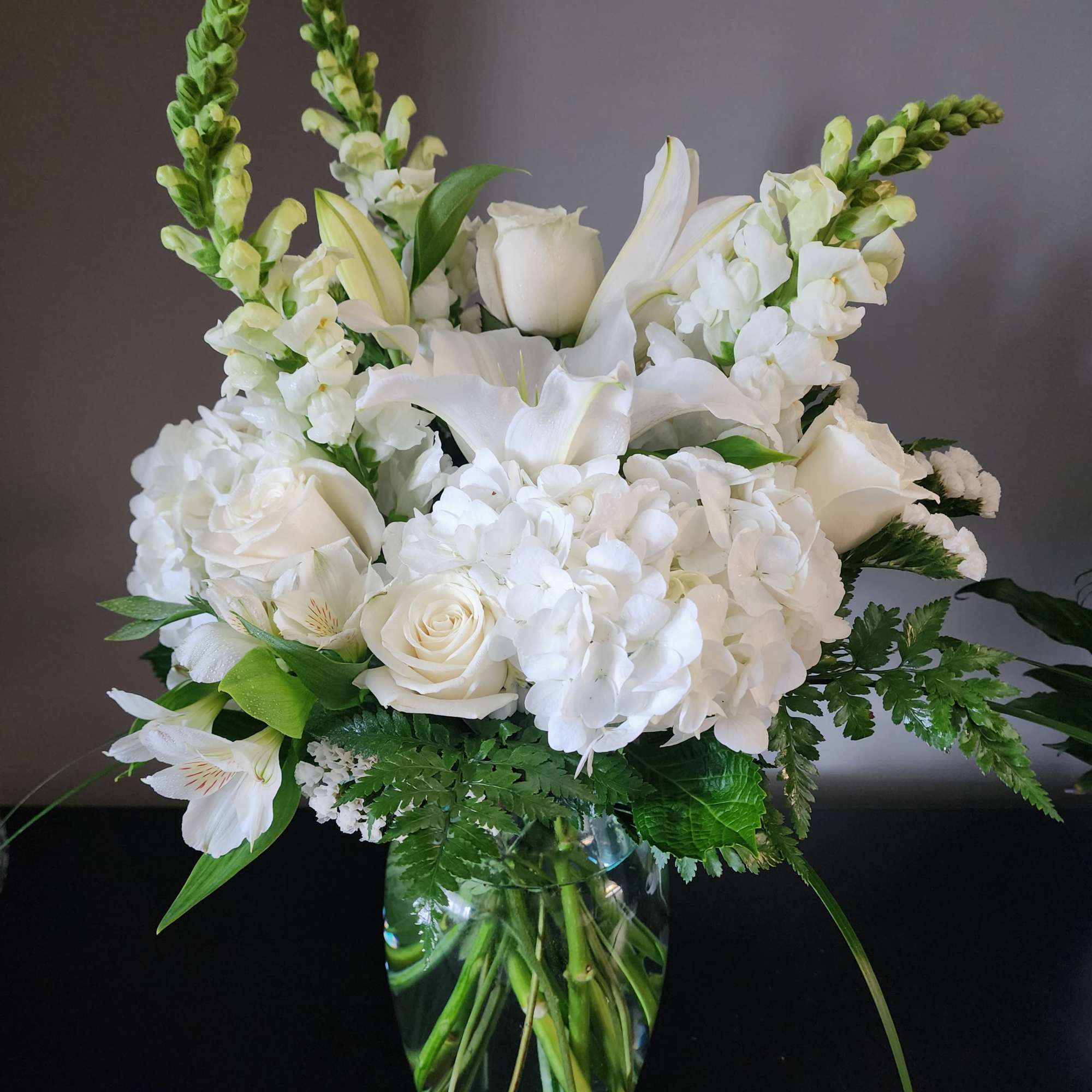Beautifully designed in a vase with roses, lilies, snapdragons, hydrangea, alstroemeria, statice