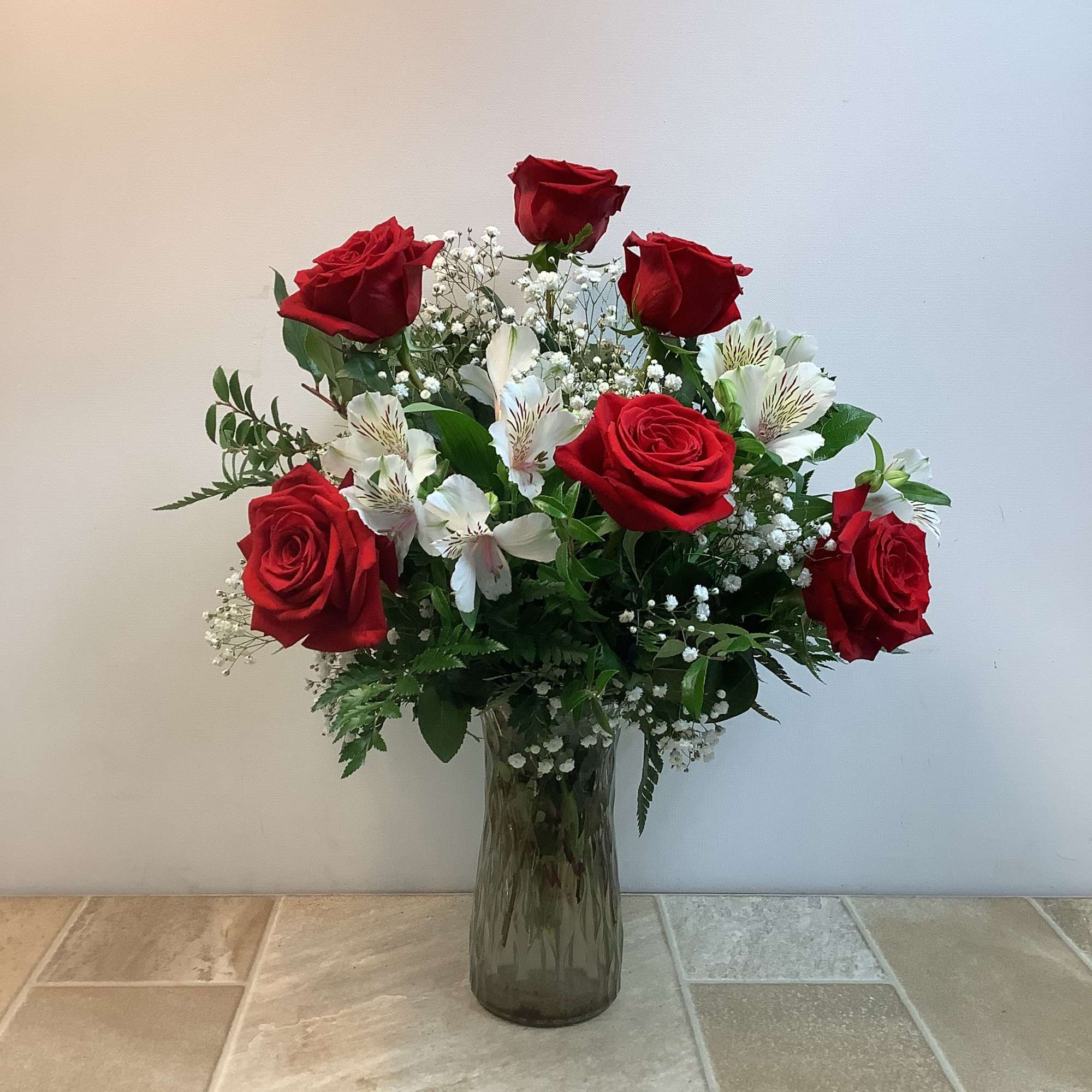 This classic bouquet features a half dozen rich, velvety red roses arranged