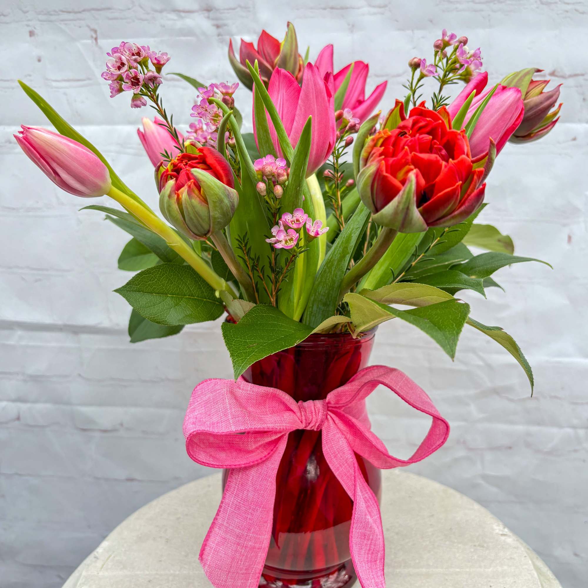 Red and hot pink tulips pop with passion in a glossy red