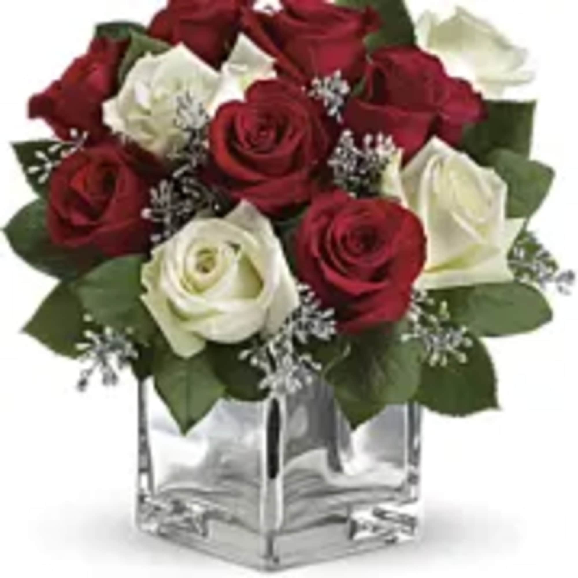 Give Christmas a charmingly contemporary spin with lush red and white roses