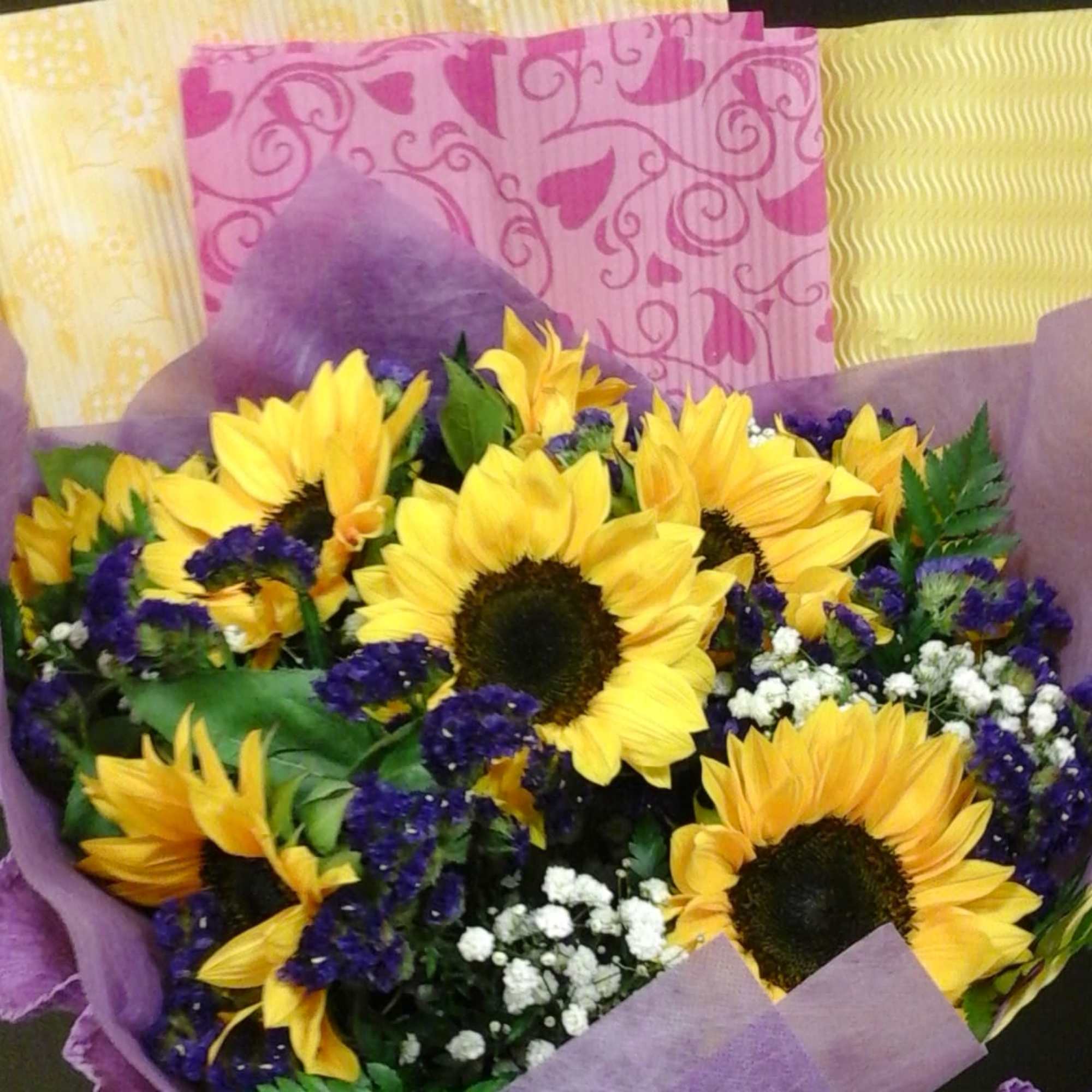 Sunflower and statice flowers wrapped in beautiful craft papers