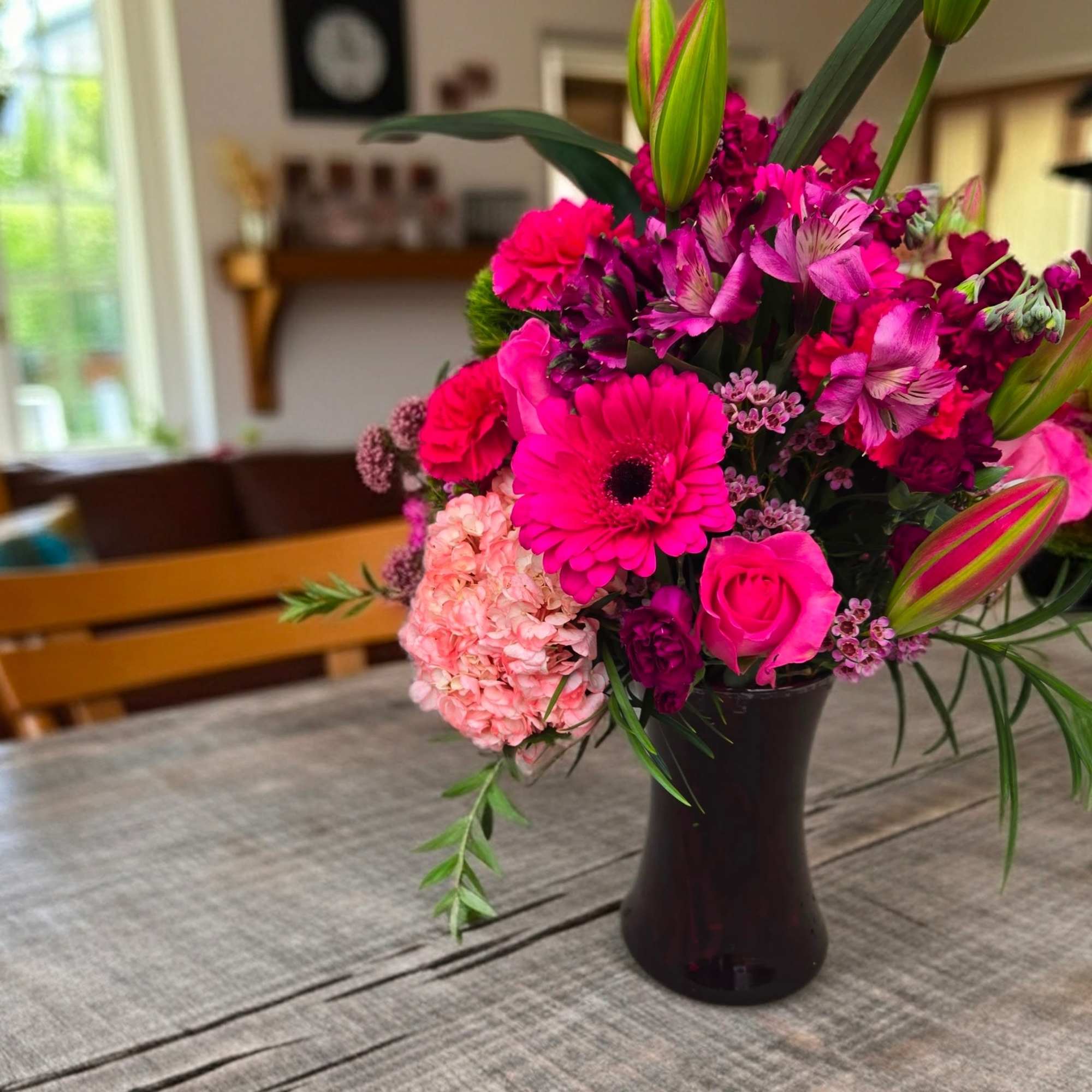 One dozen of the most festive roses plus fluffy baby's-breath.