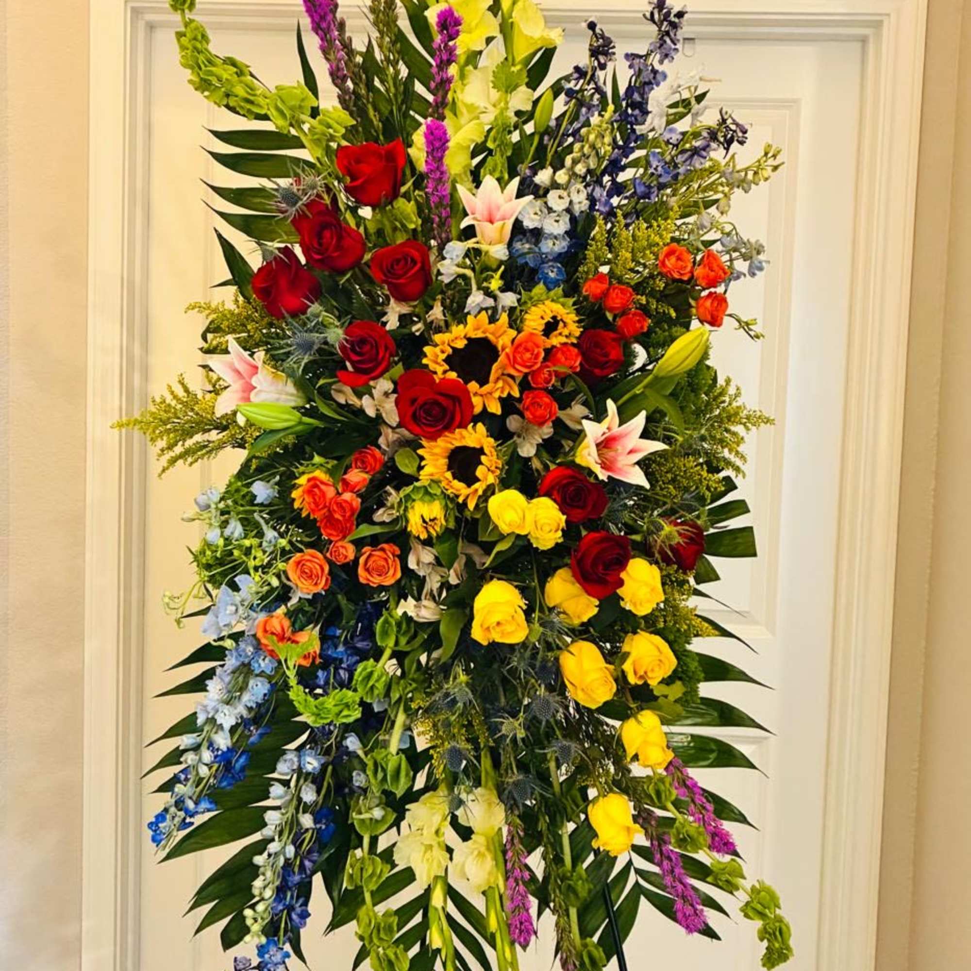 Colorful Standing Funeral Spray with Sunflowers &amp; Roses

This vibrant standing funeral spray