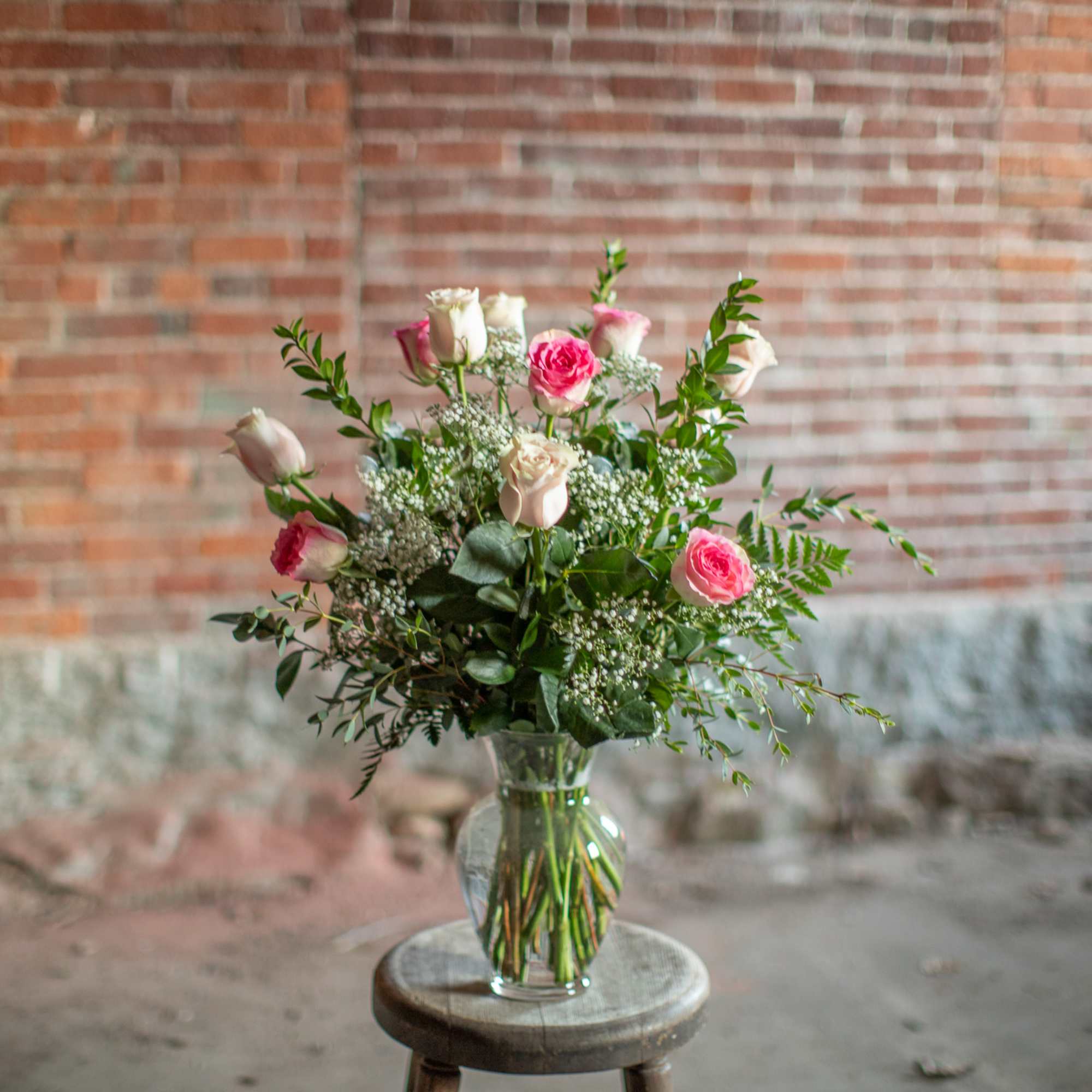 Pretty, premium long stem pink roses are arranged in an all around