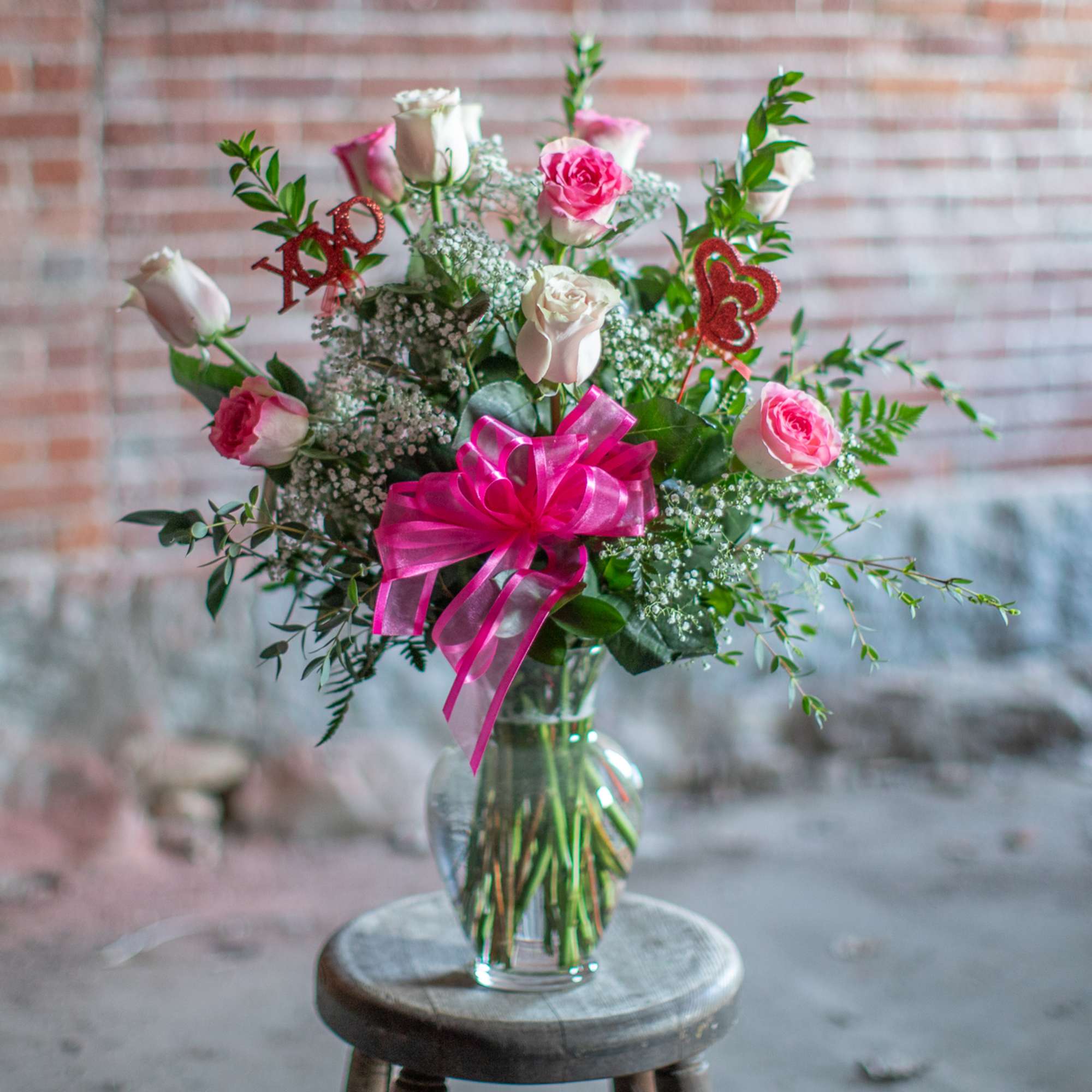 Pretty, premium long stem pink roses are arranged in an all around