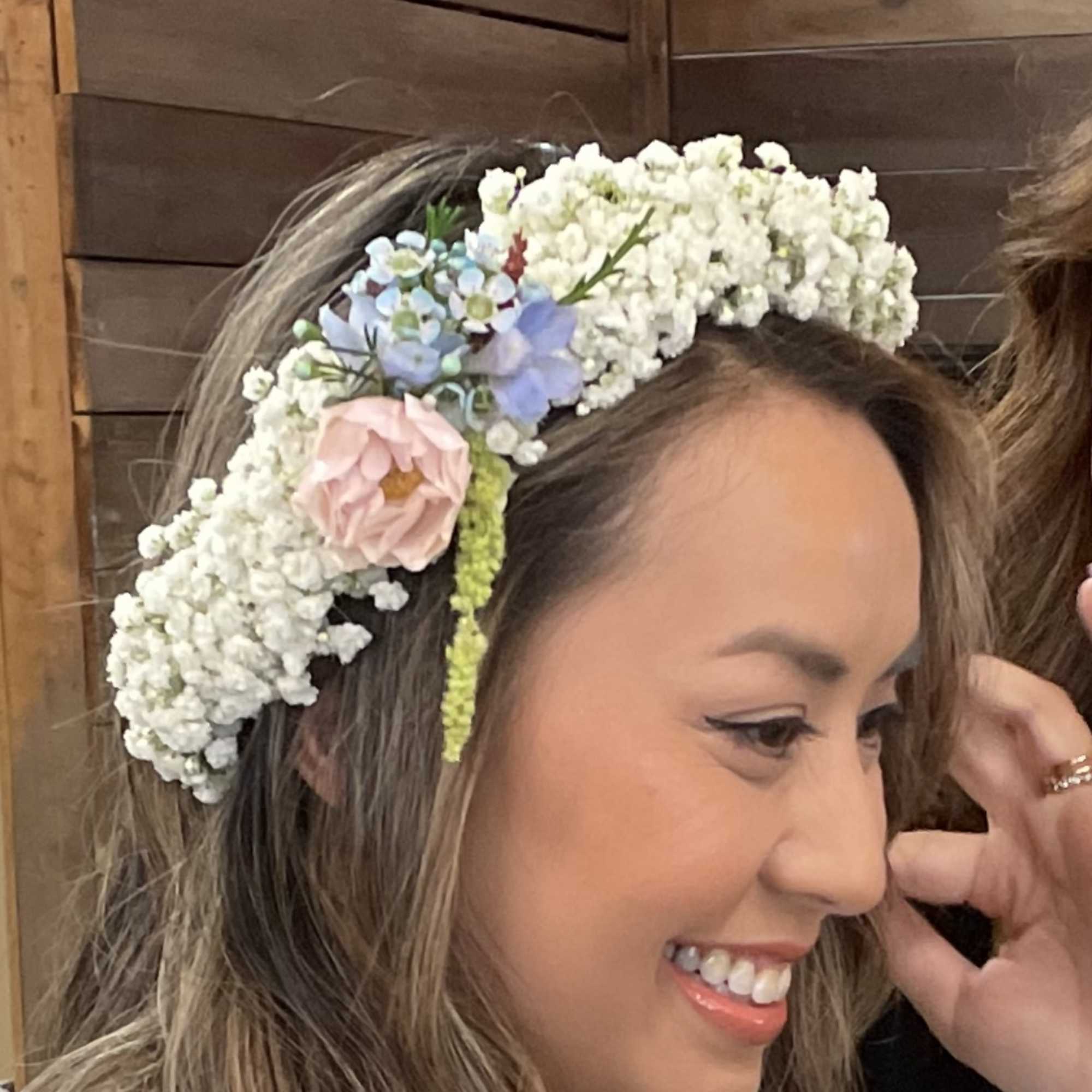 A handcrafted halo of fresh blooms, designed to be worn for weddings