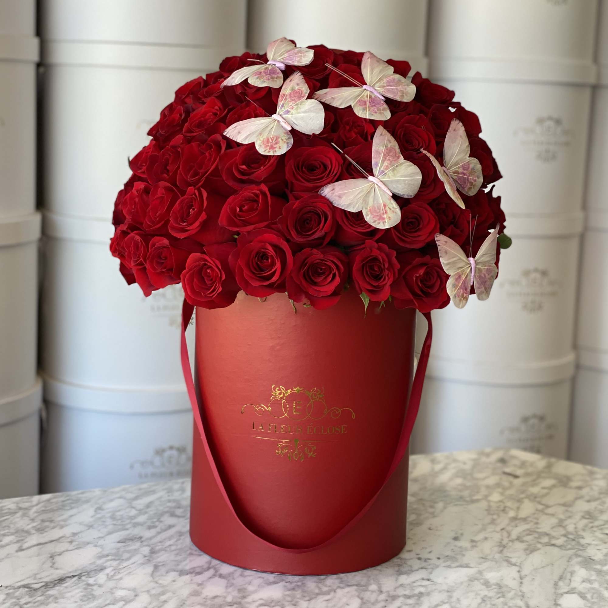 Standard 50 red roses in our signature red box with butterflies 
Deluxe