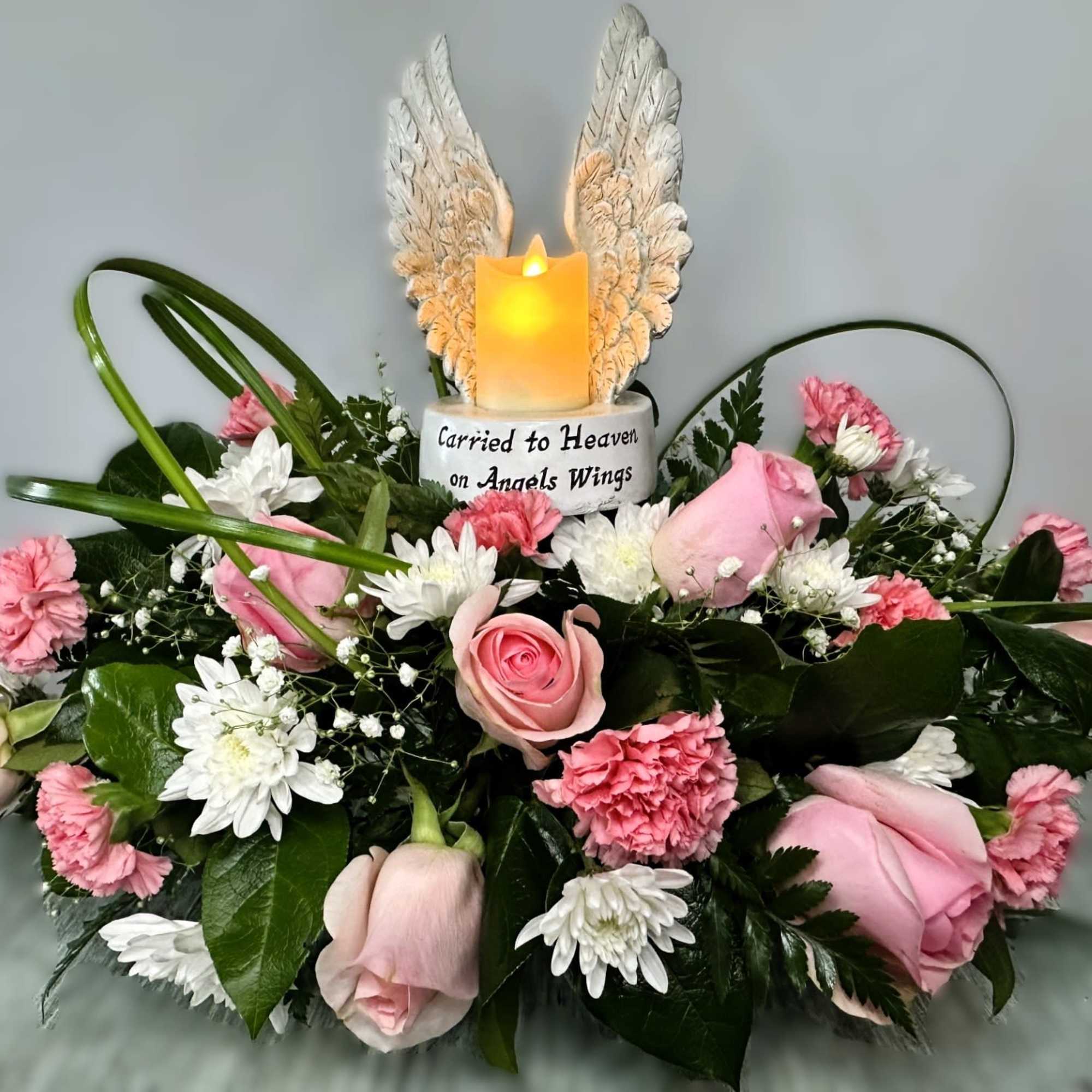 Pink and white arrangement which includes an LED Angel Wings with battery