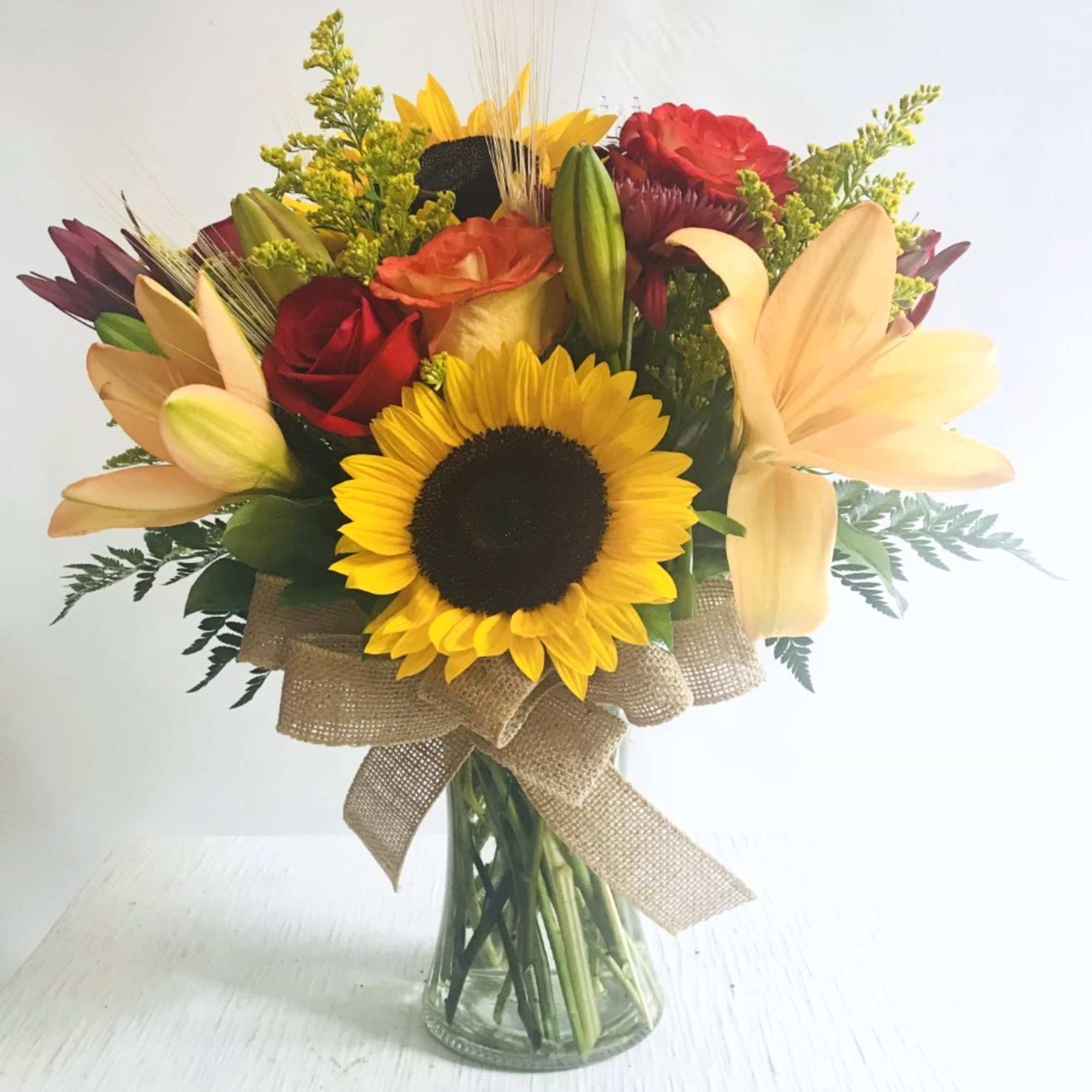 Arrangement of fresh cut flowers designed in a glass vase. Colors can