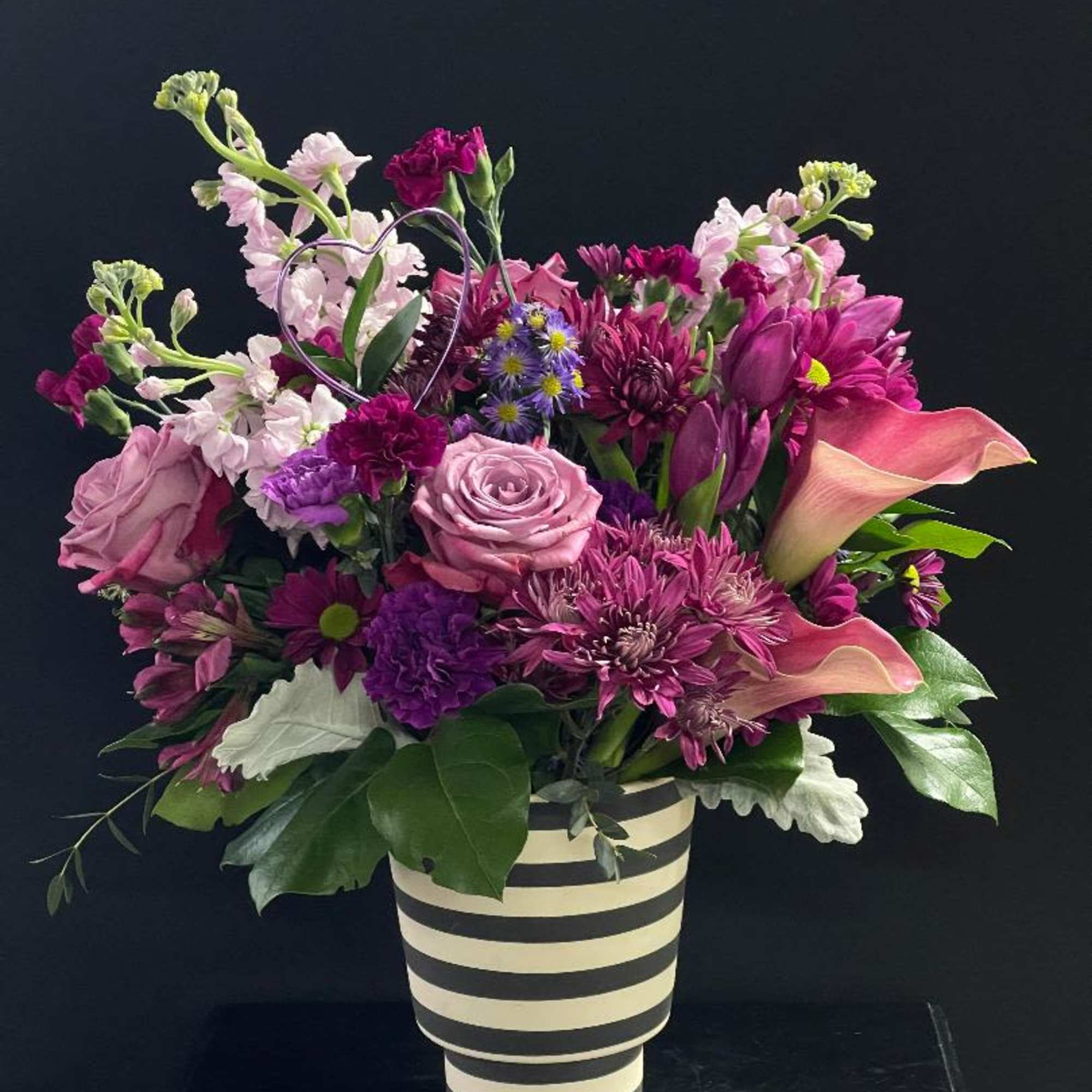 This arrangement is full of beautiful purple blooms and is perfect for