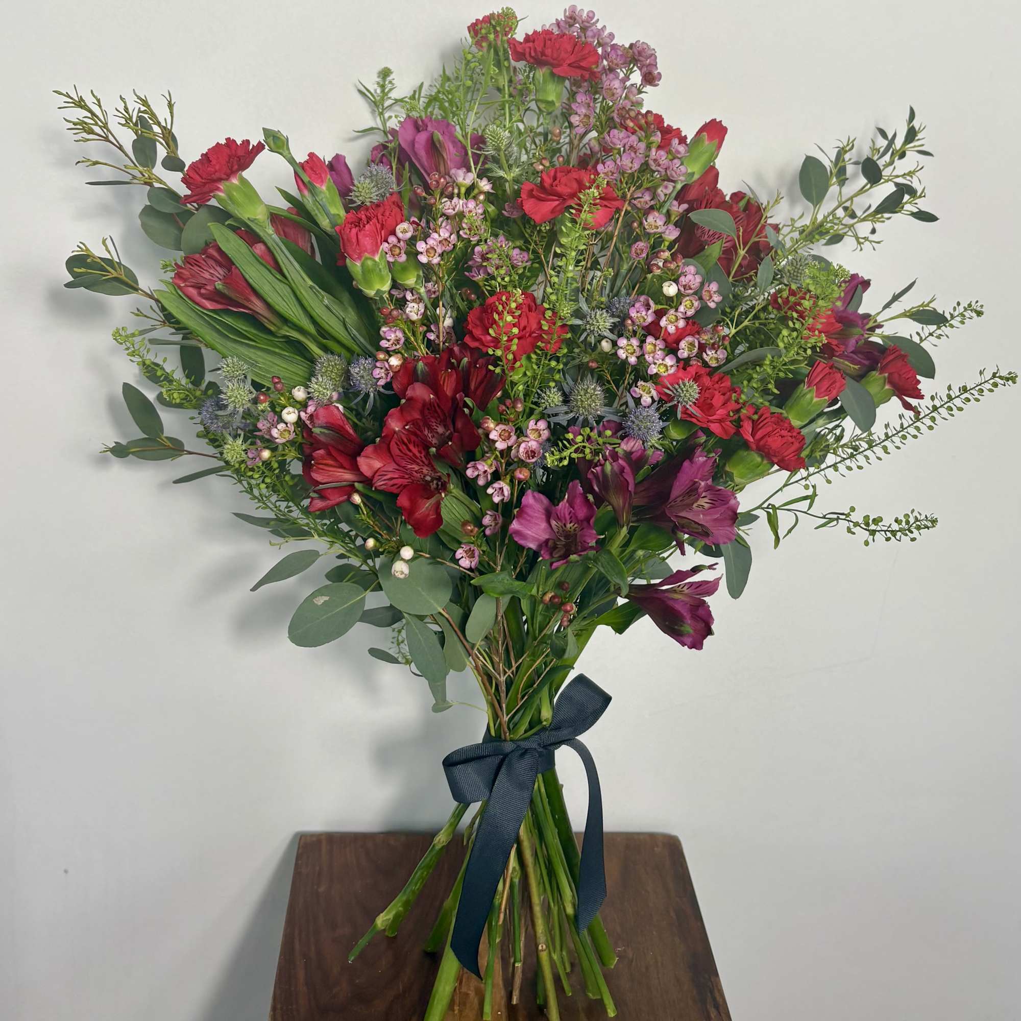 Bold, playful, and full of personality, this Mixed Red Floral Bouquet is