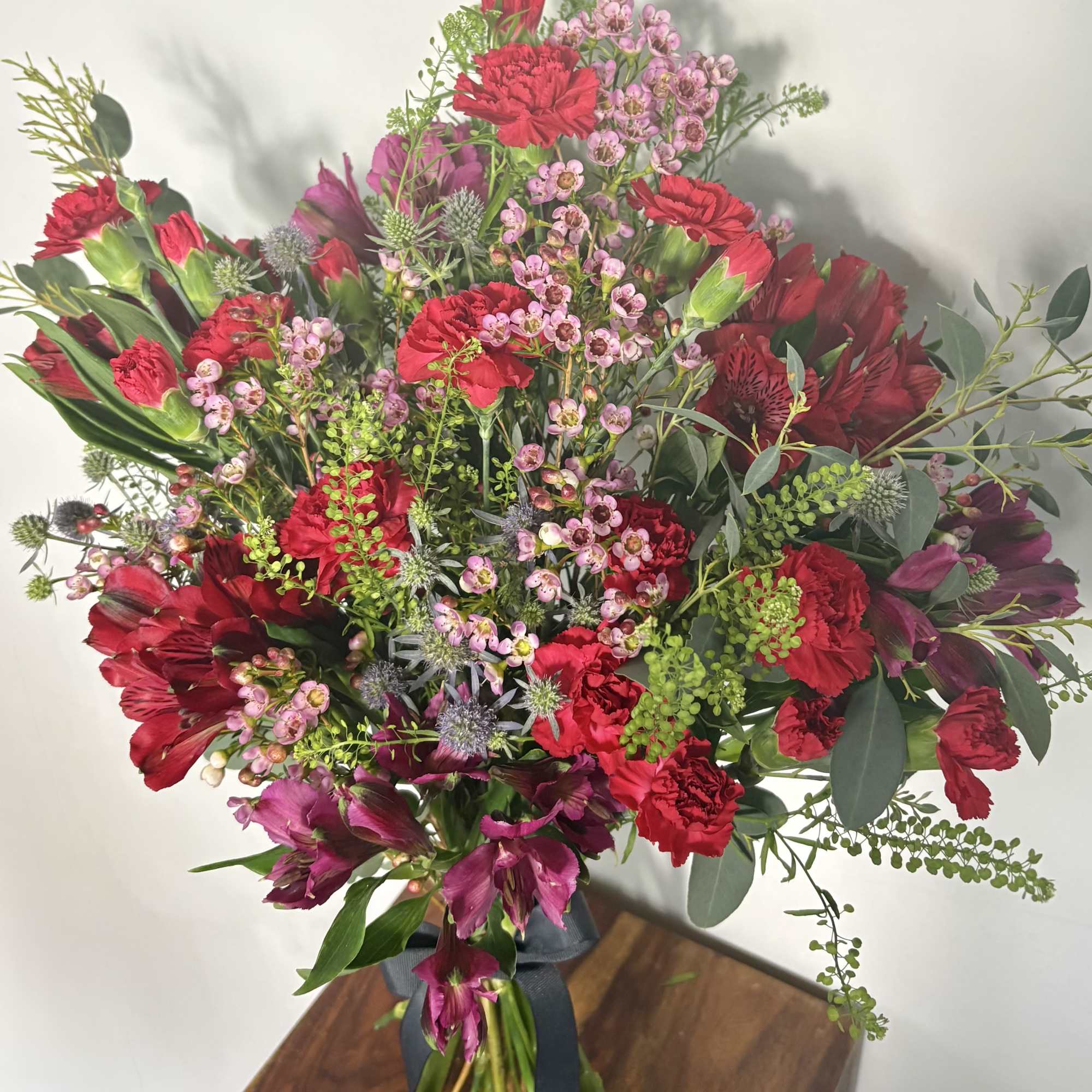 Bold, playful, and full of personality, this Mixed Red Floral Bouquet is