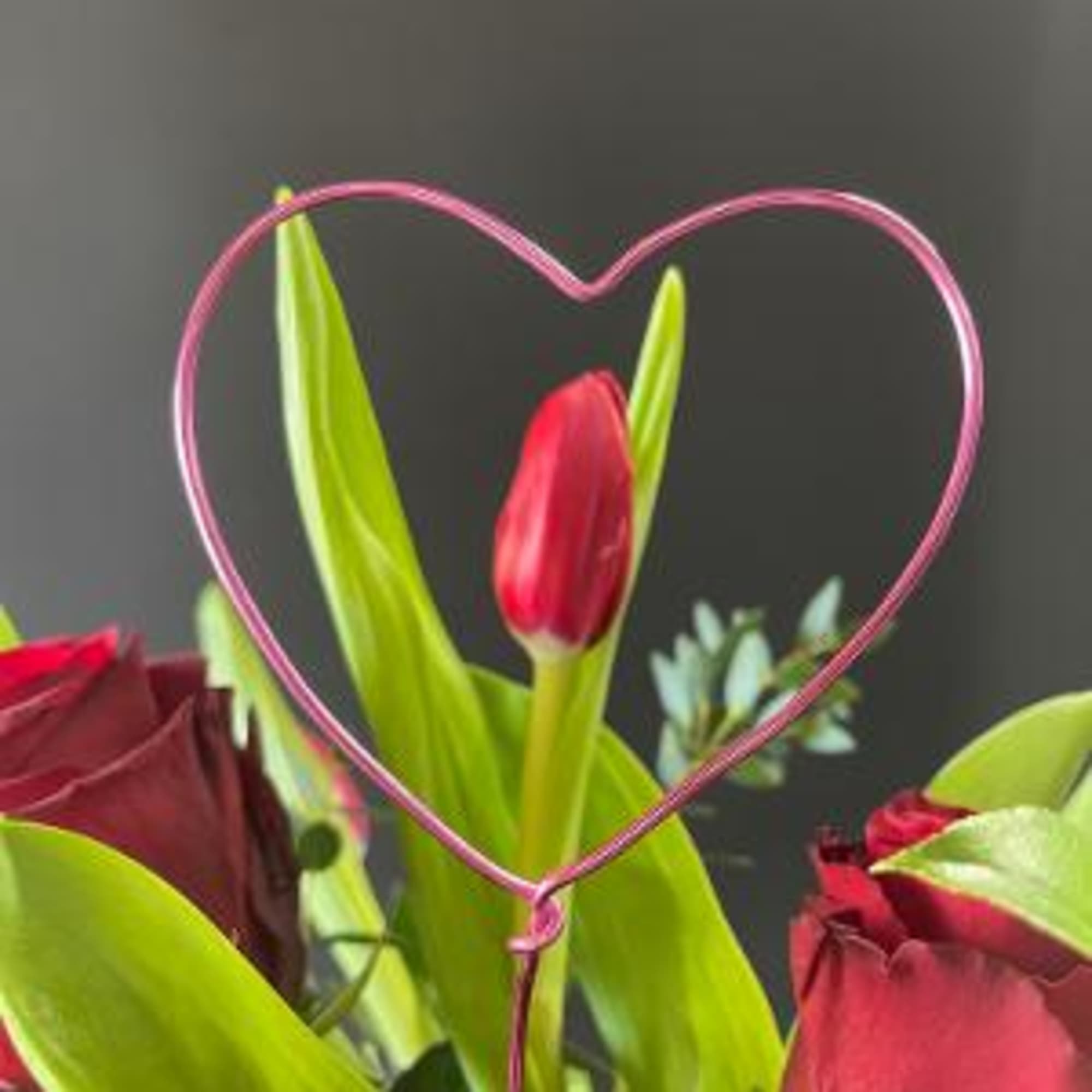 This arrangement is super sweet with tulips and roses.  Fragrant and