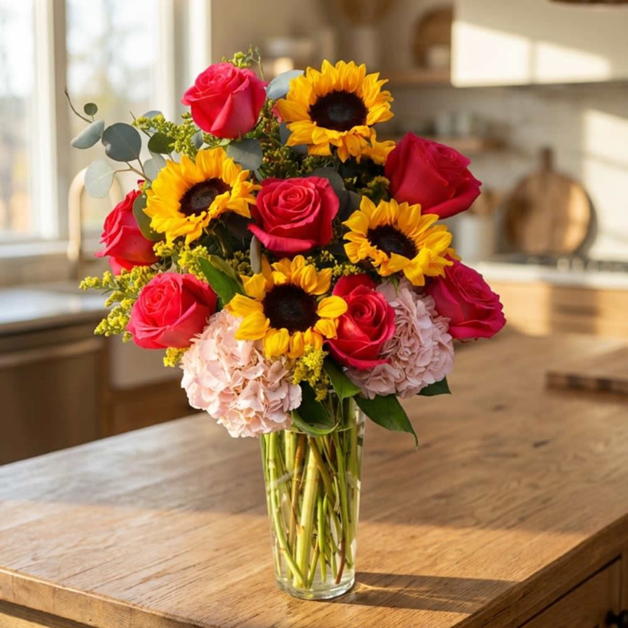 This vibrant arrangement blends golden sunflowers with lush hot pink roses and