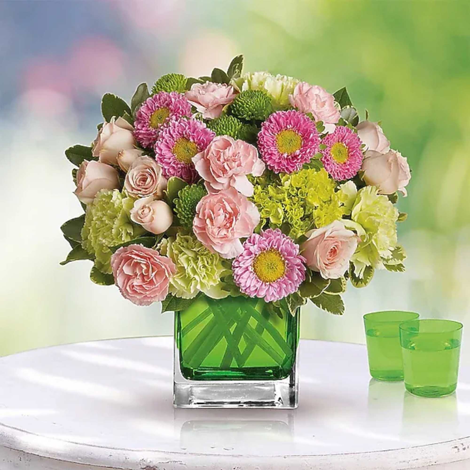 Sweetly sophisticated, this arrangement of green miniature hydrangea and light pink spray