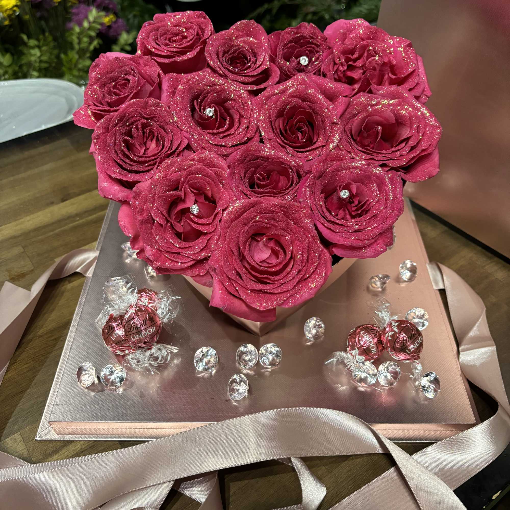 Roses shaped into heart, chocolates and diamonds