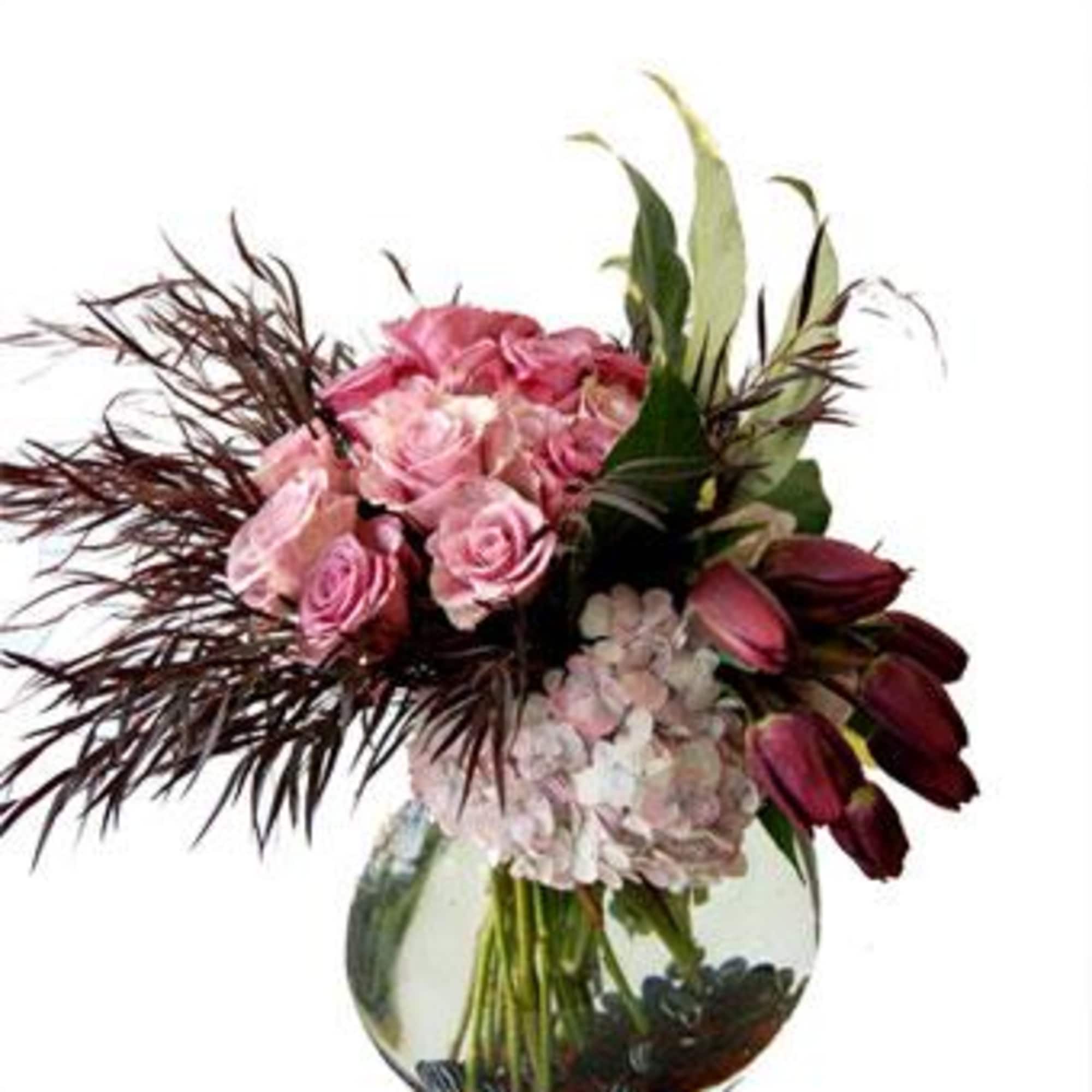 A unique floral arrangement consisting of soft pink roses, dark pink tulips