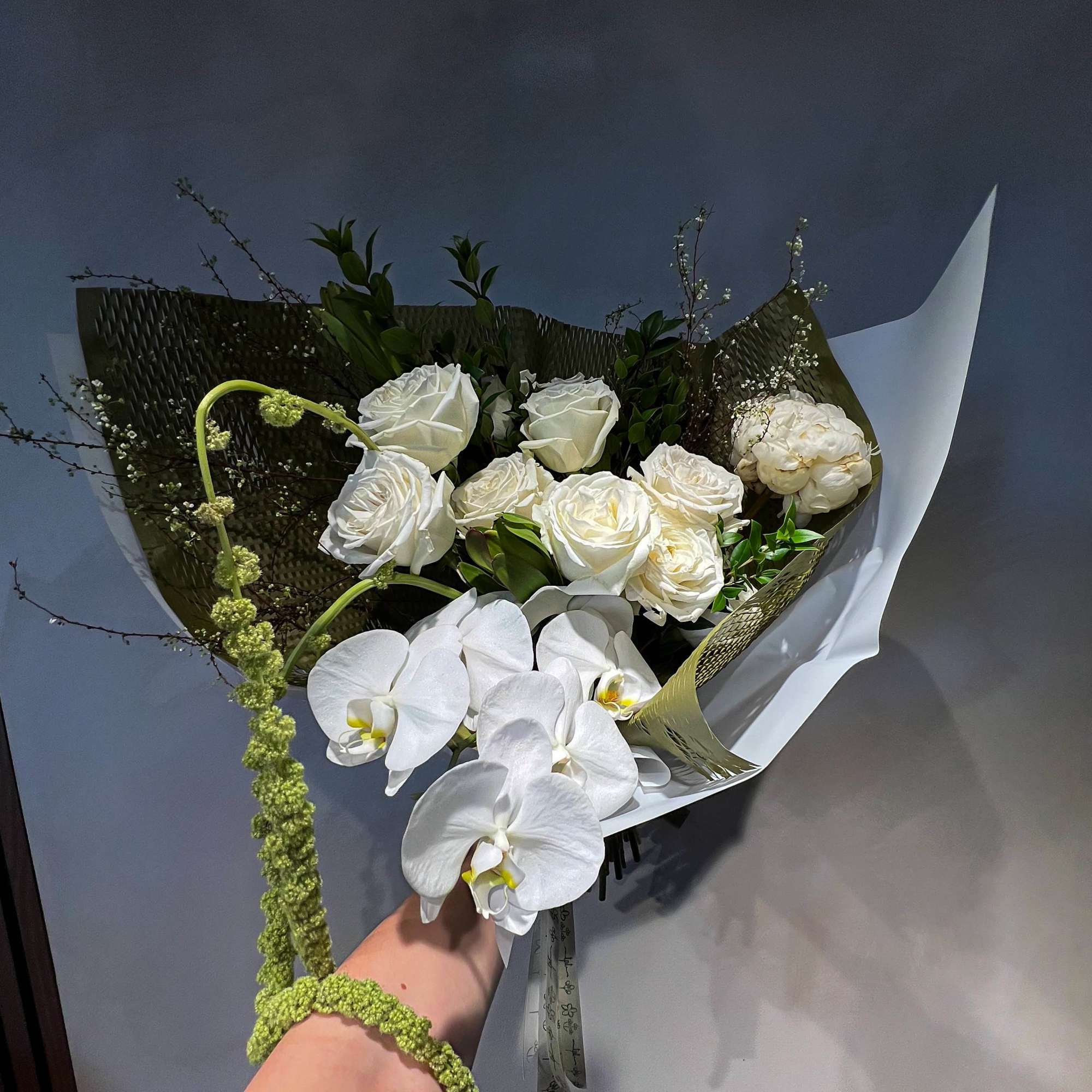 An all-white Valentine&rsquo;s Day bouquet of white flowers and fresh greenery, designed