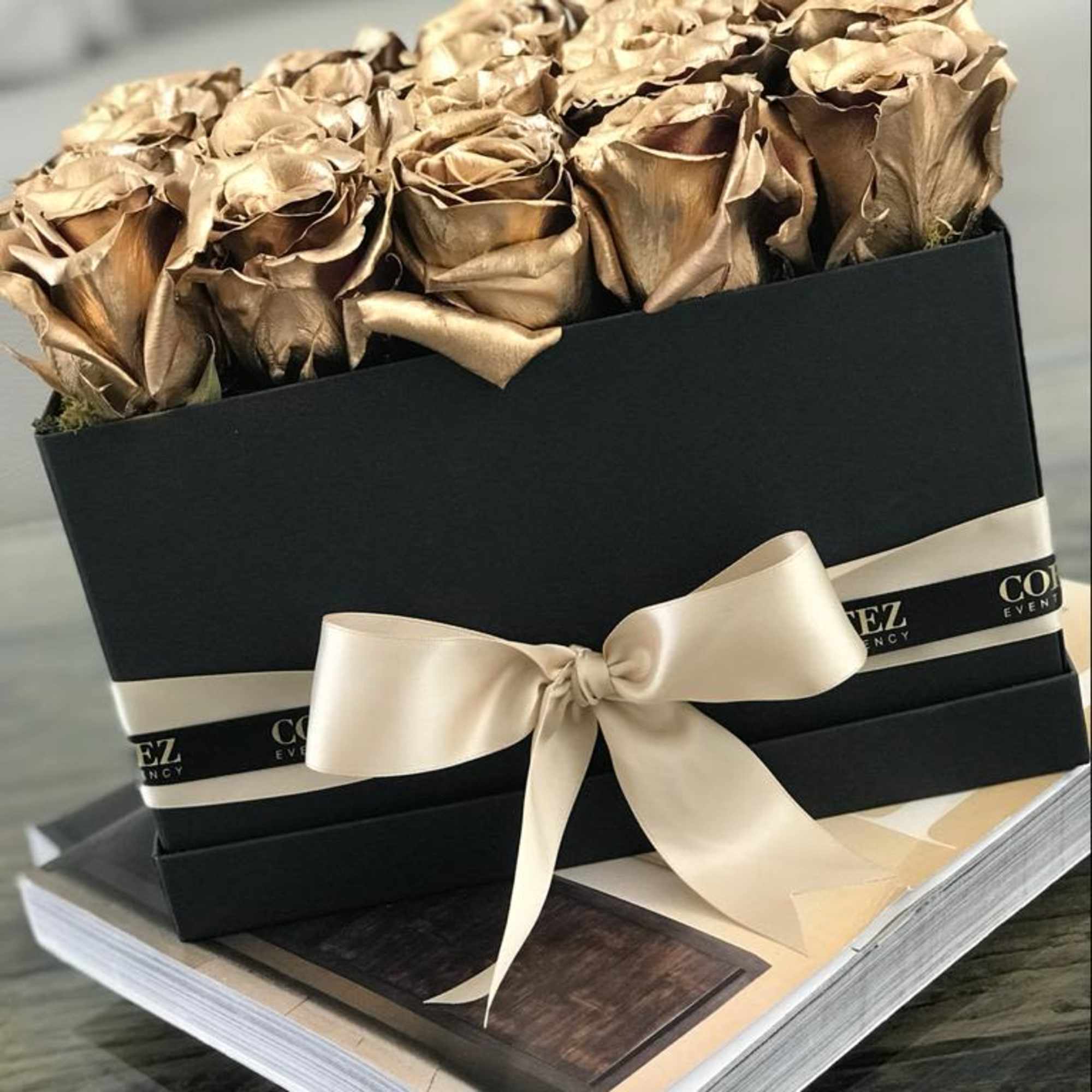 Elegant box filled with approximately 20 gold roses, offering a luxurious and
