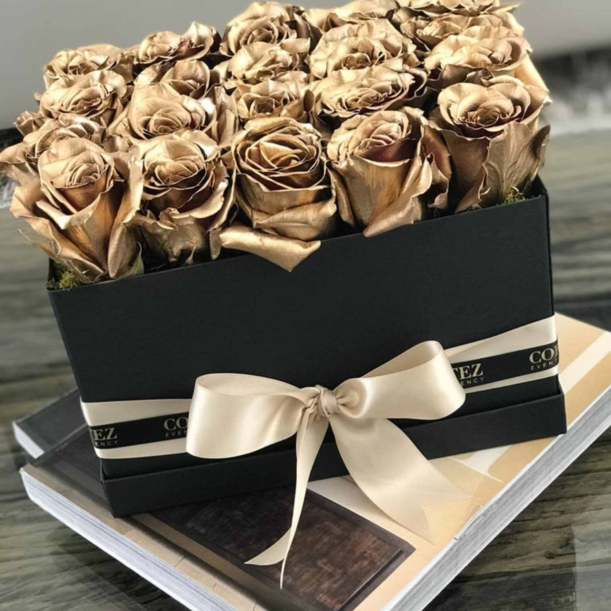 Elegant box filled with approximately 20 gold roses, offering a luxurious and