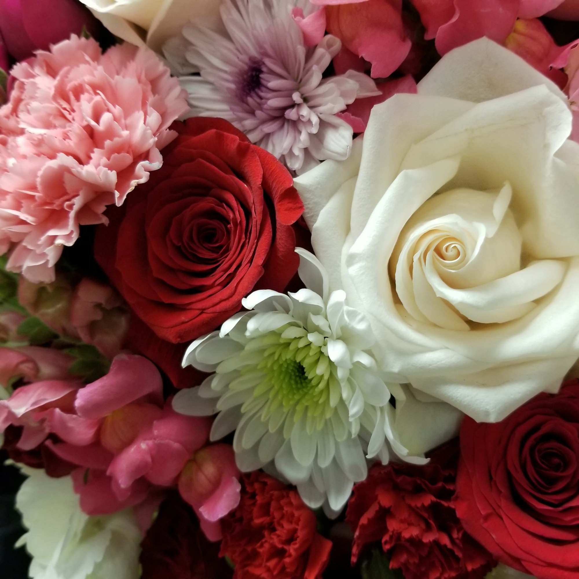 Our talented designers will create a beautiful Valentine's arrangement in traditional Valentine's