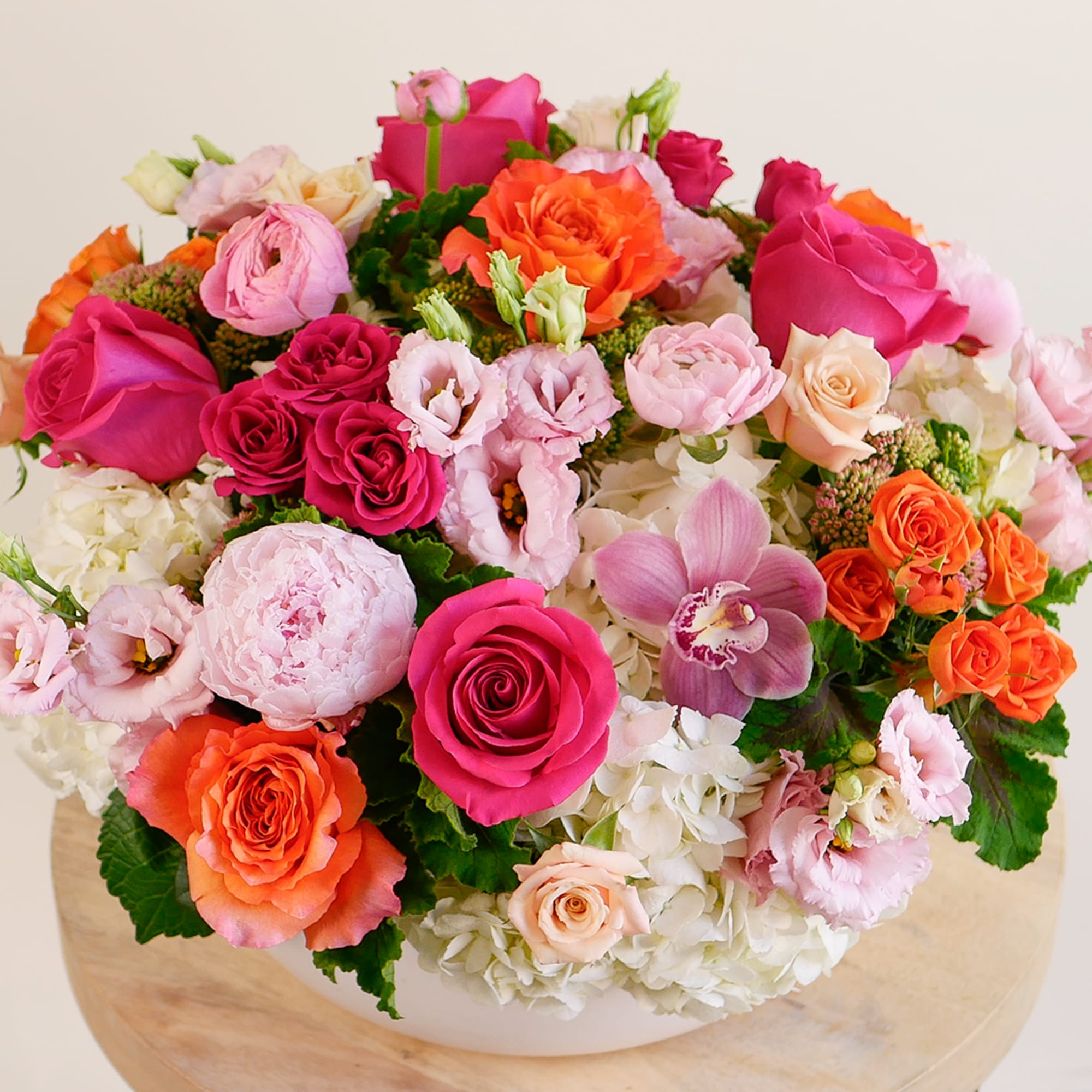 This sizable arrangement features our best collection of vibrant pink and orange