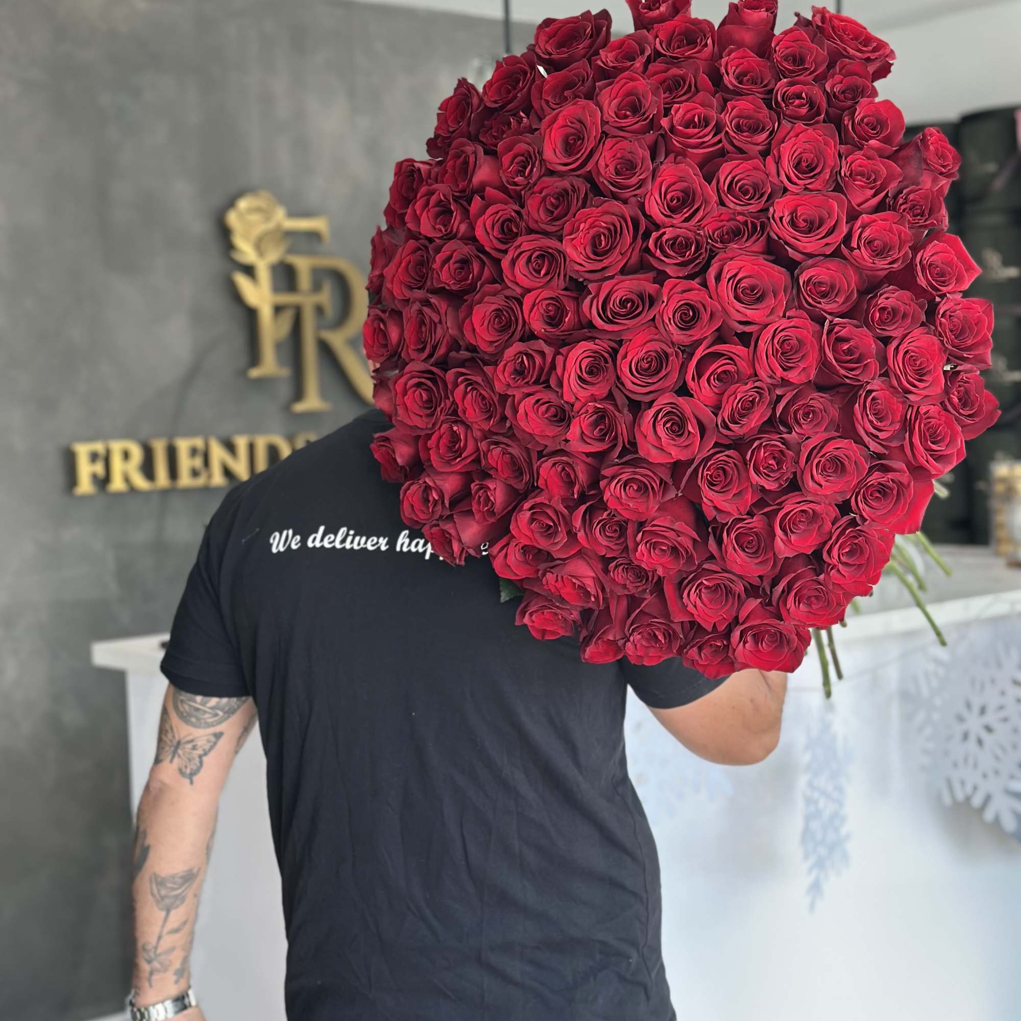 A stunning bouquet of 100 extra long - stemmed red roses, elegantly