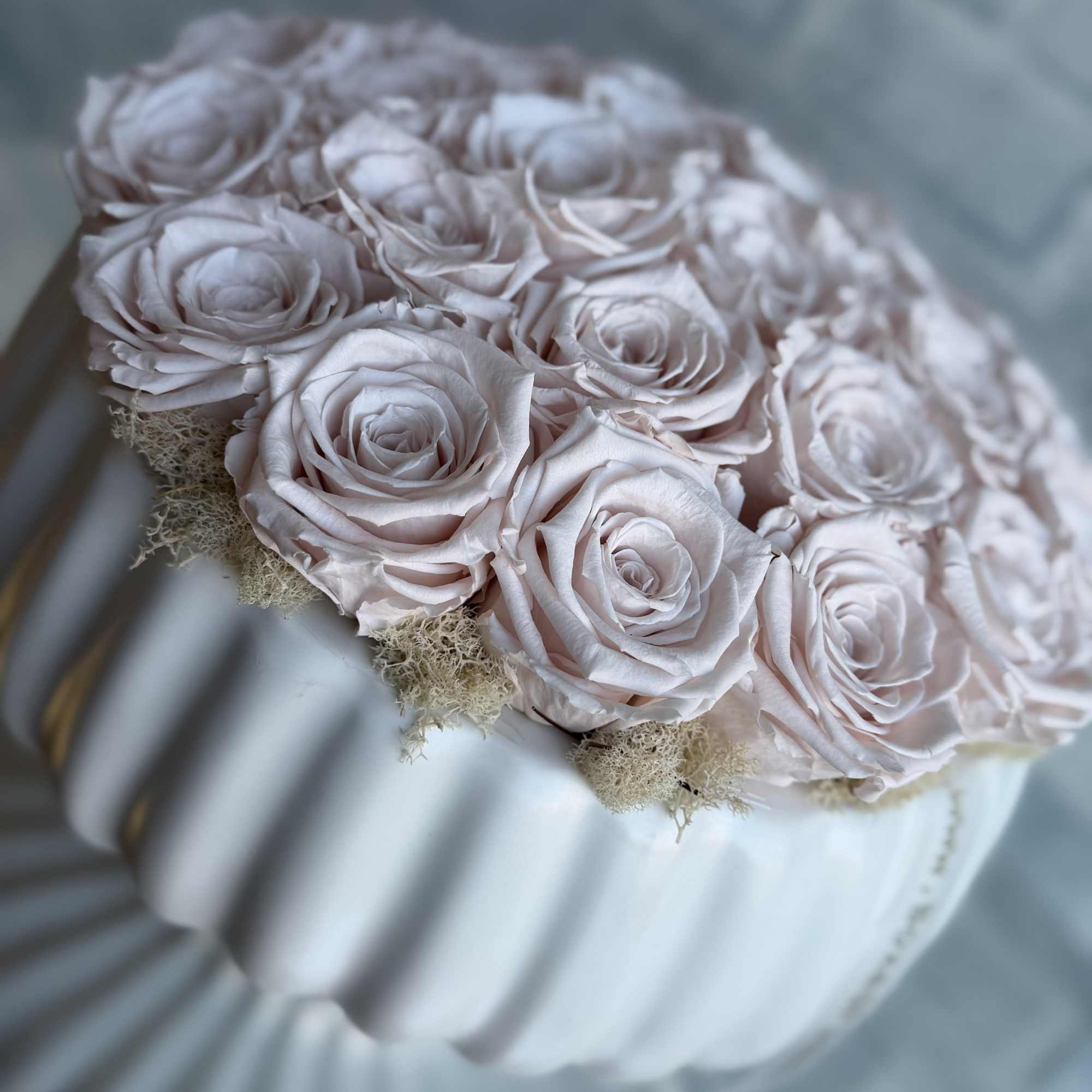 28 beautiful preserved blush roses floating on a gorgeous ceramic white vase.