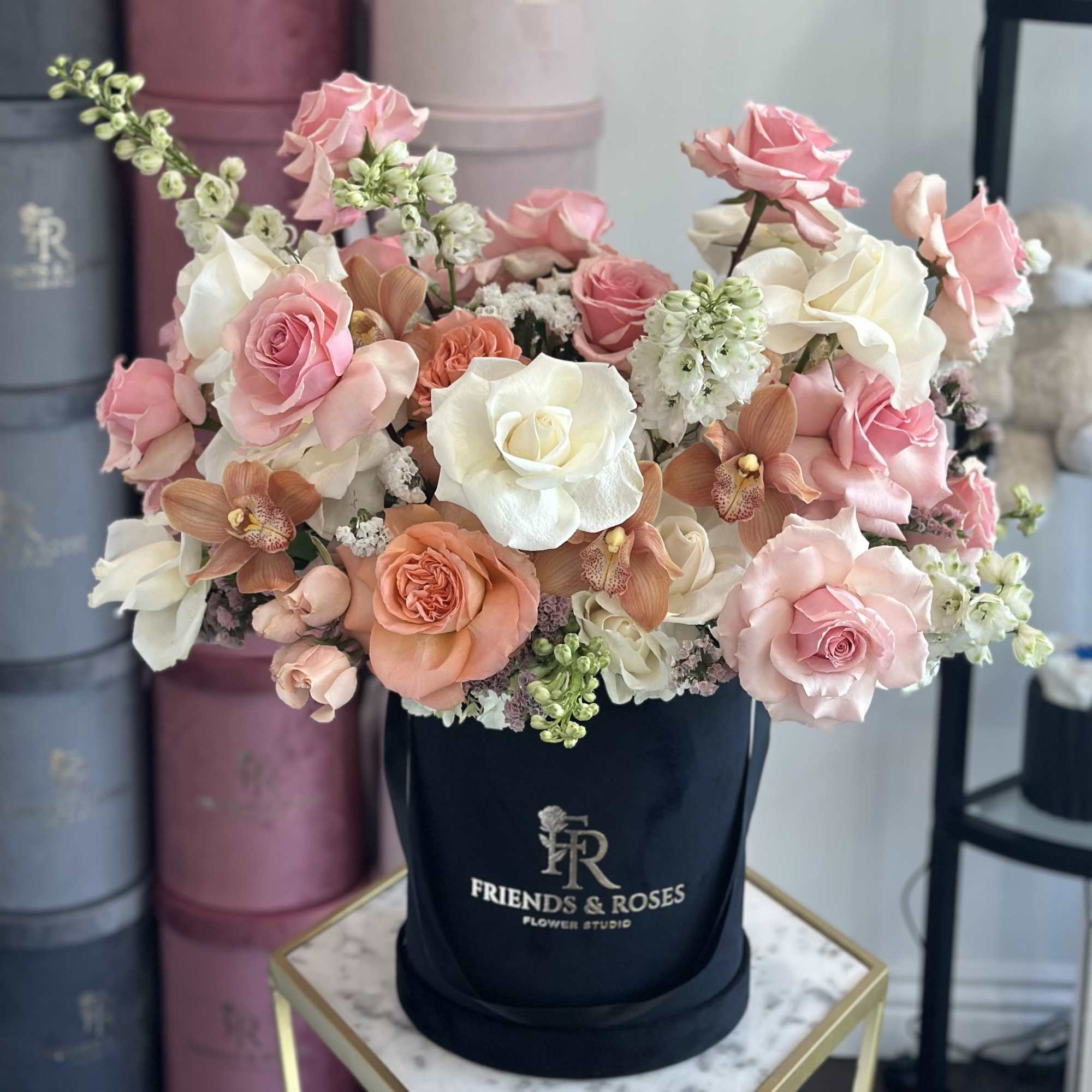 A soft and elegant arrangement in our signature box. Delicate roses in