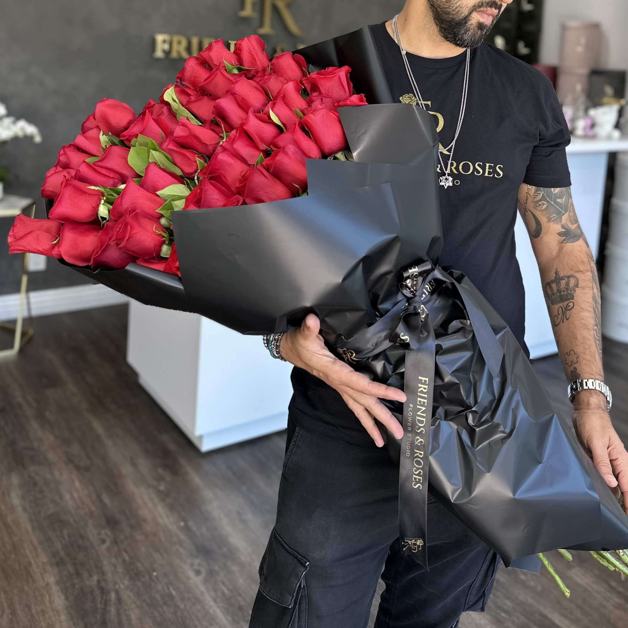 A gorgeous handcrafted bouquet of  red roses in a wrapping black