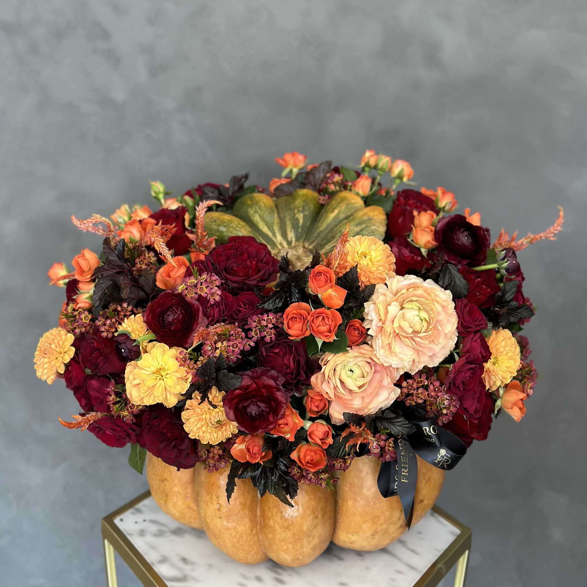 A stunning fall arrangement in red monochromatic colors makes an excellent centerpiece