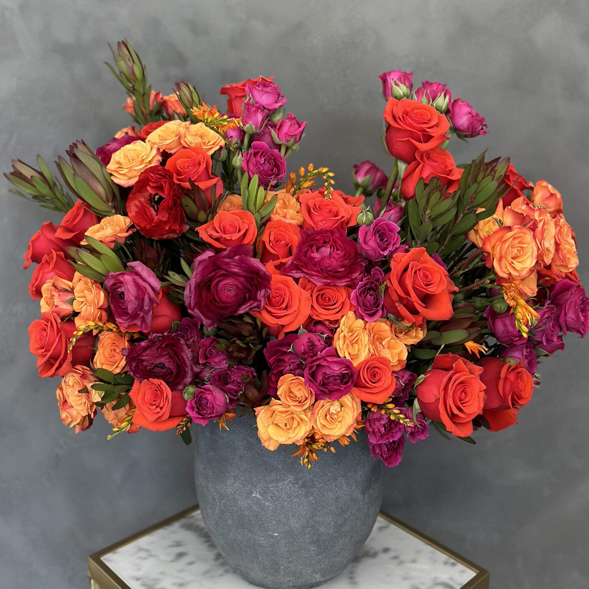 A one-of-a-kind vase arrangement created by our top designer will bring a