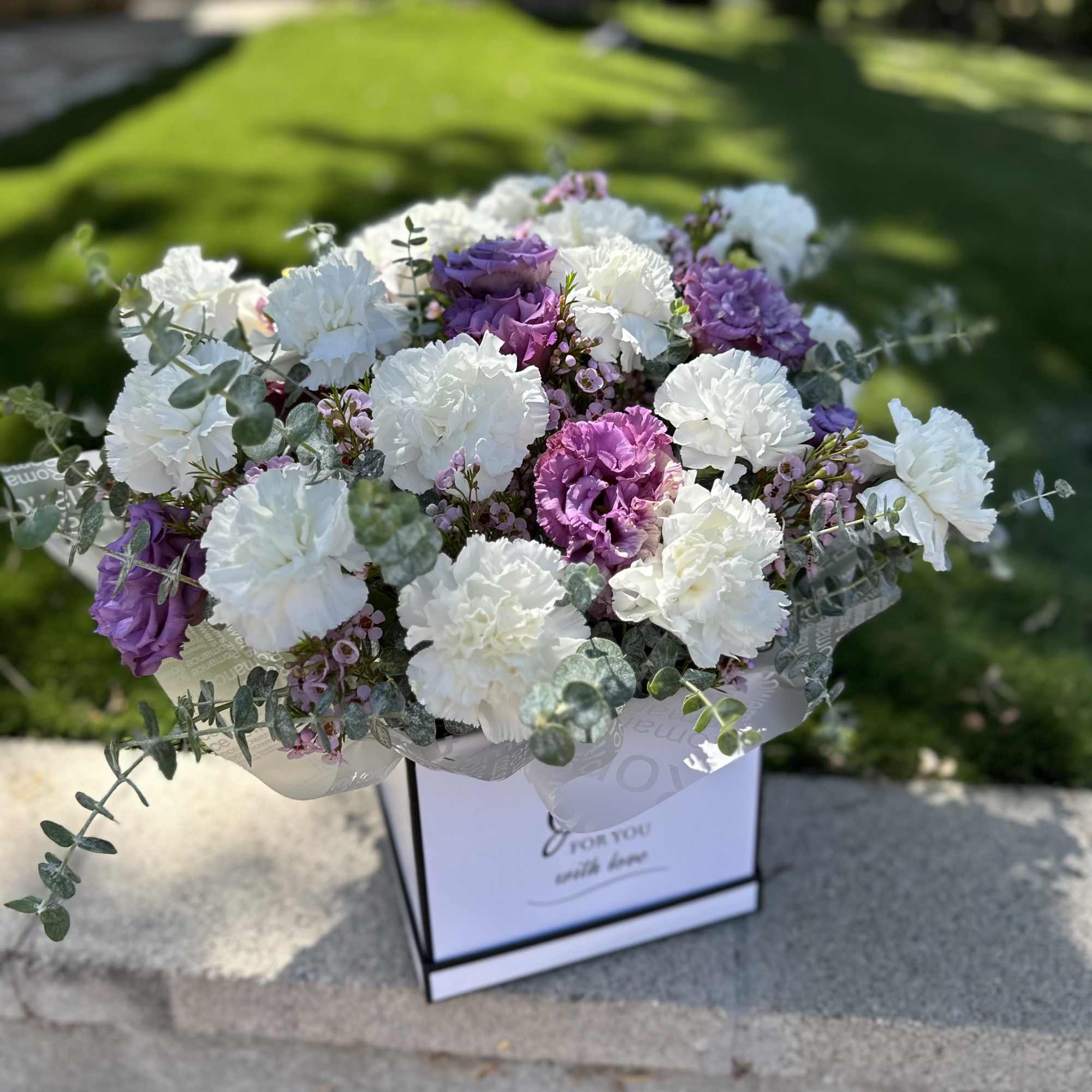 Minimalism with character. Snow-white carnations and lilac lisianthus form a contrasting yet