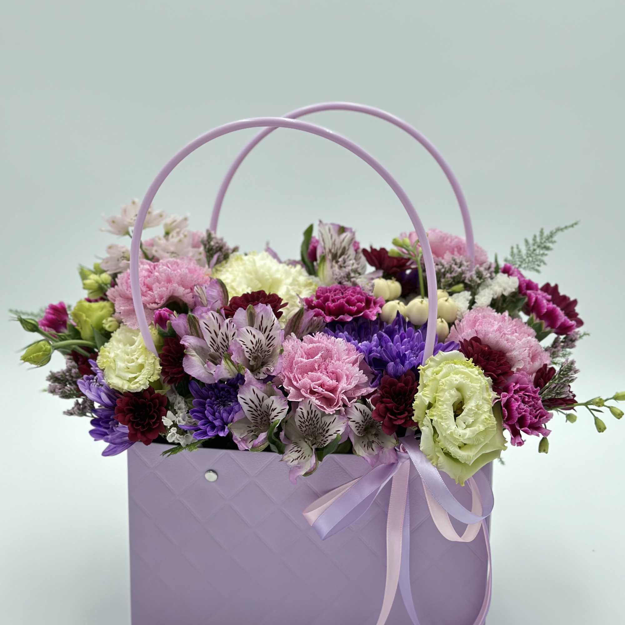 This arrangement in a handbag is made for those who appreciate elegance