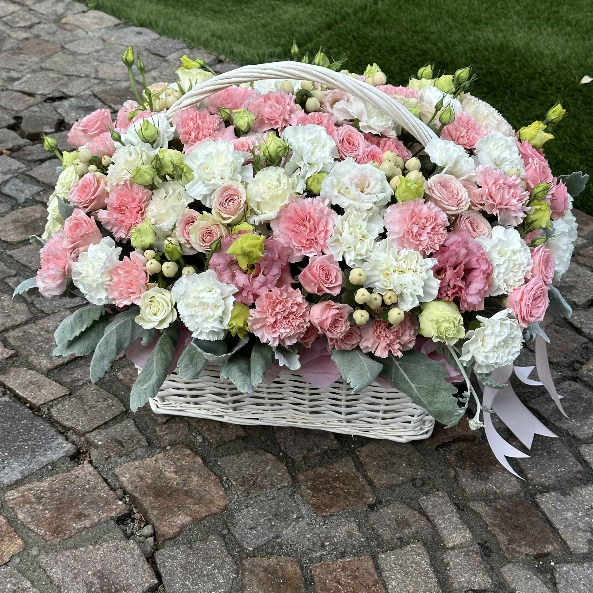 A luxurious floral basket filled with an abundance of delicate blooms in