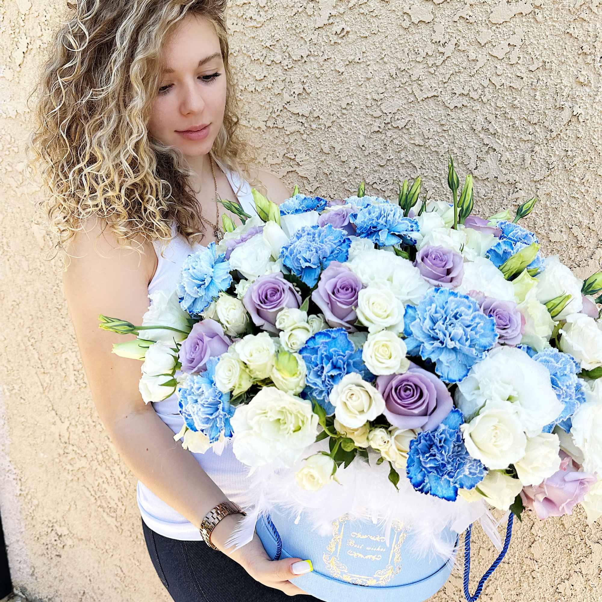 A tender floral arrangement in soft blue, light purple and white tones